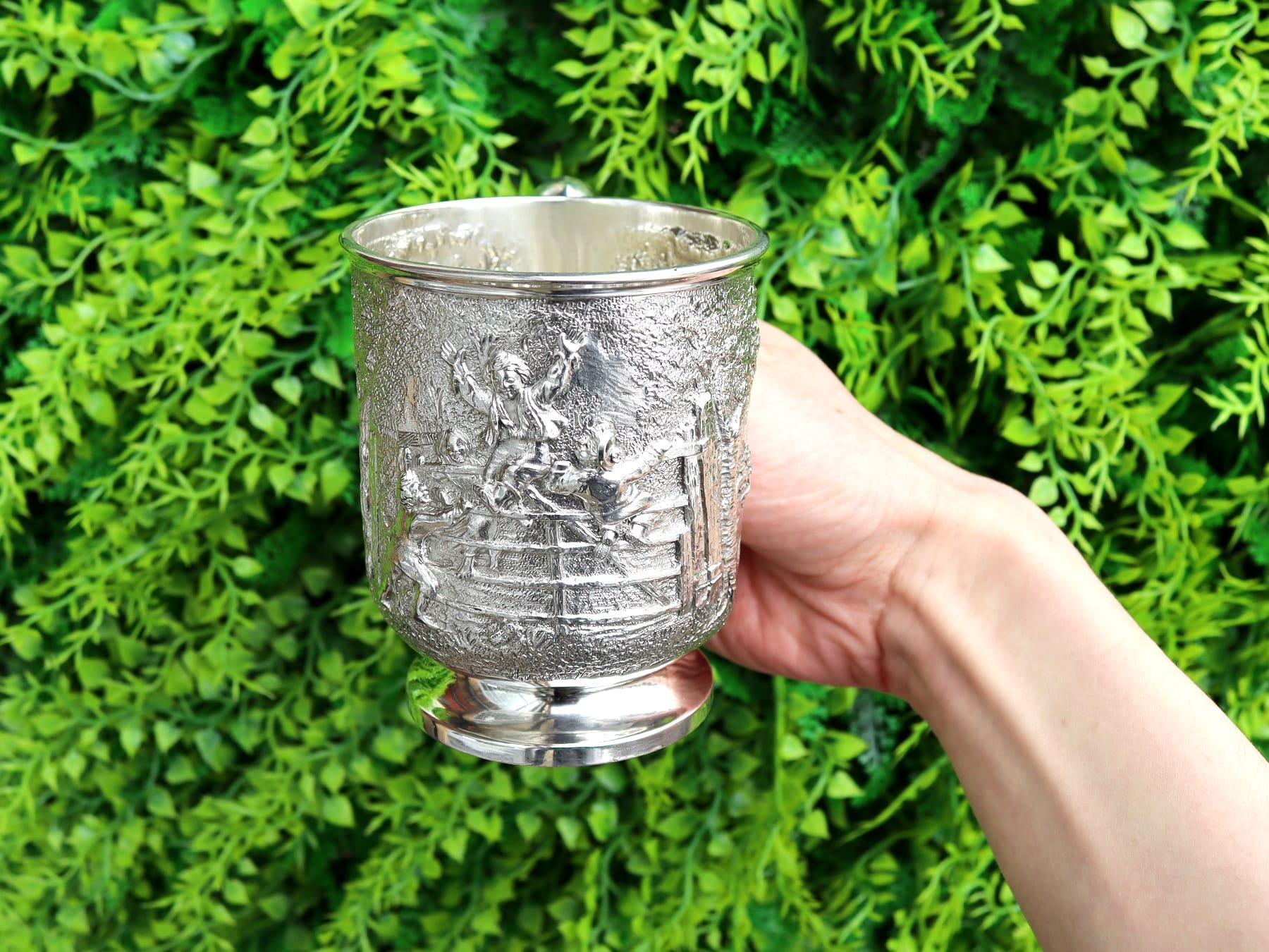 An exceptional, fine and impressive antique Victorian English sterling silver mug; an addition to our silver christening gifts collection.

This exceptional antique Victorian sterling silver mug has a circular rounded form to a plain circular