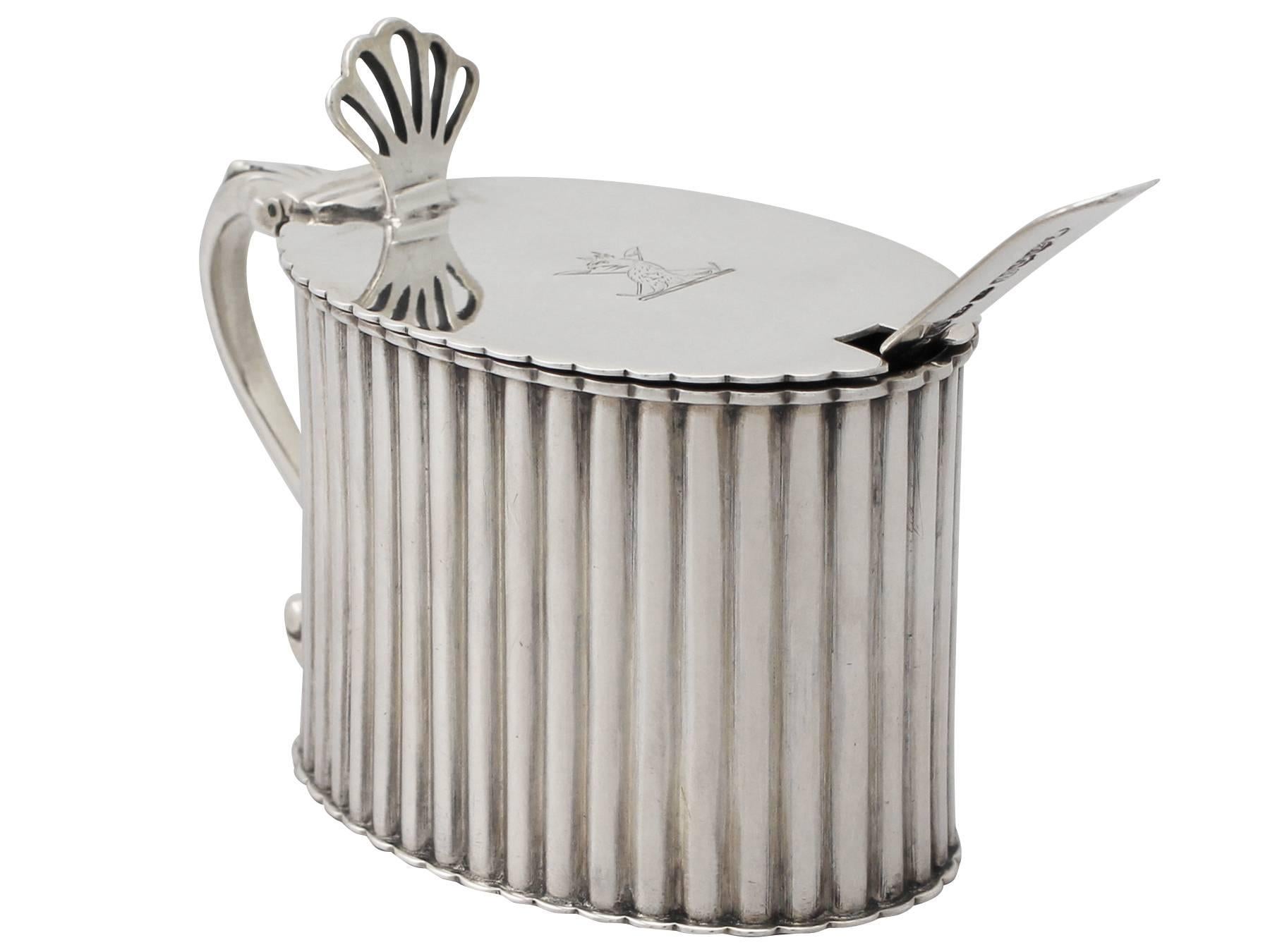 An exceptional, fine and impressive, large antique Victorian English sterling silver mustard pot; an addition to our silver condiments collection.

This fine antique Victorian sterling silver mustard pot has an oval form.

The body is encircled