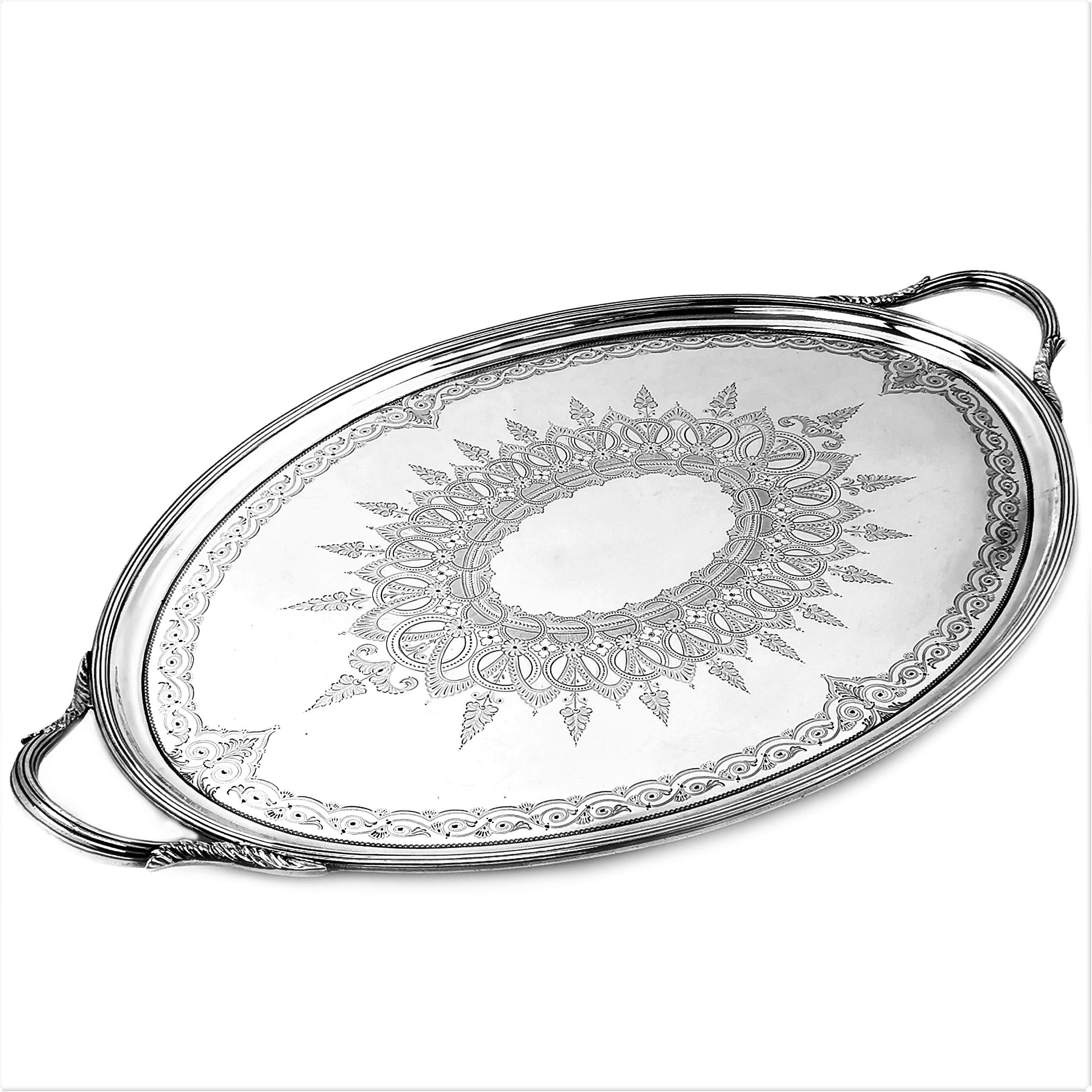A beautiful Antique Victorian solid silver two handled Serving Tea Tray with a classic oval form. The Tray has two reeded handles decorated with stylized acanthus leaf designs. The interior of the Tray has a magnificent ornate engraved design in the