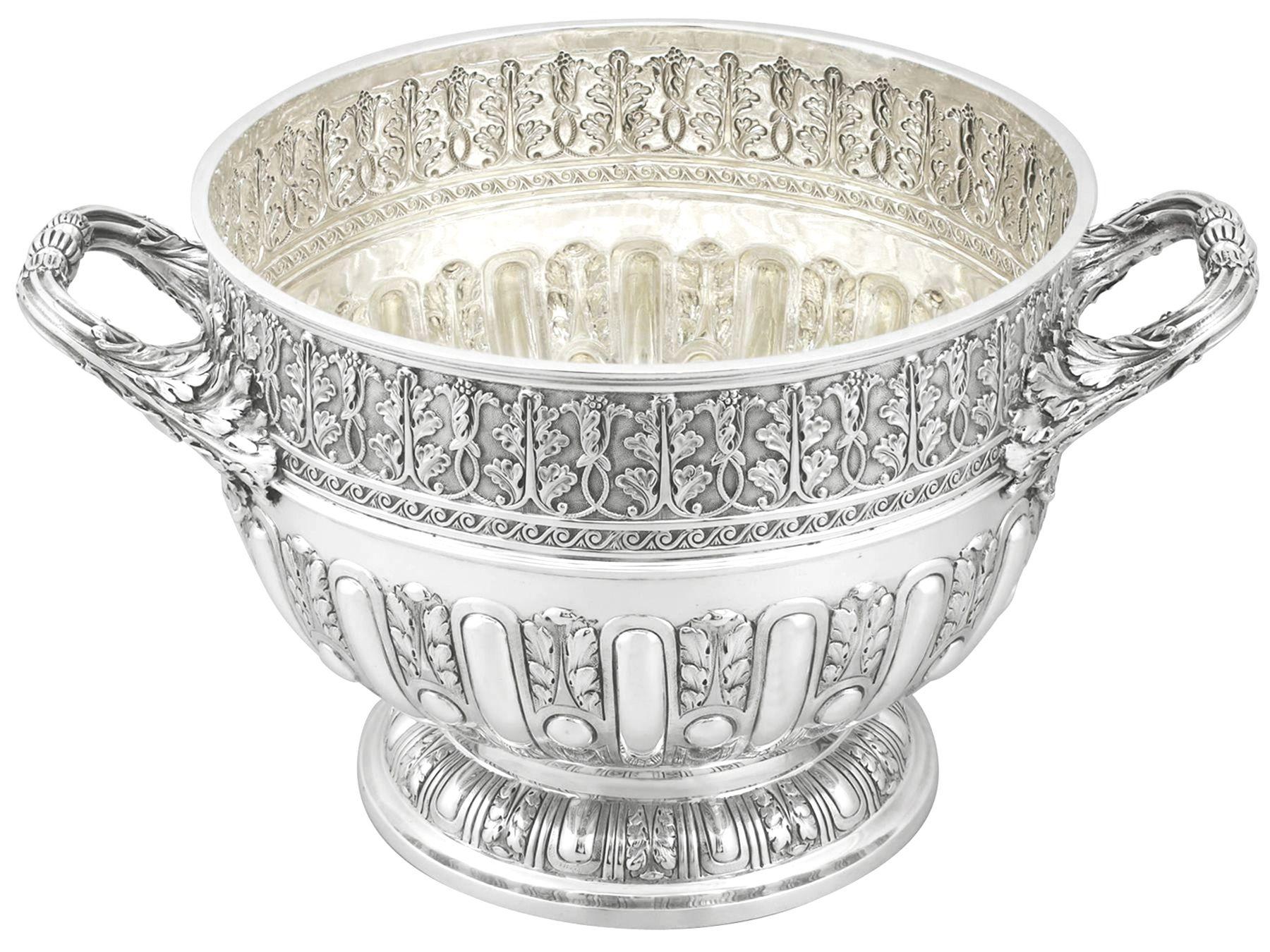 A magnificent, fine and impressive antique Victorian English sterling silver presentation bowl; an addition to our ornamental silverware collection.

This magnificent antique Victorian sterling silver bowl has a circular rounded form onto a