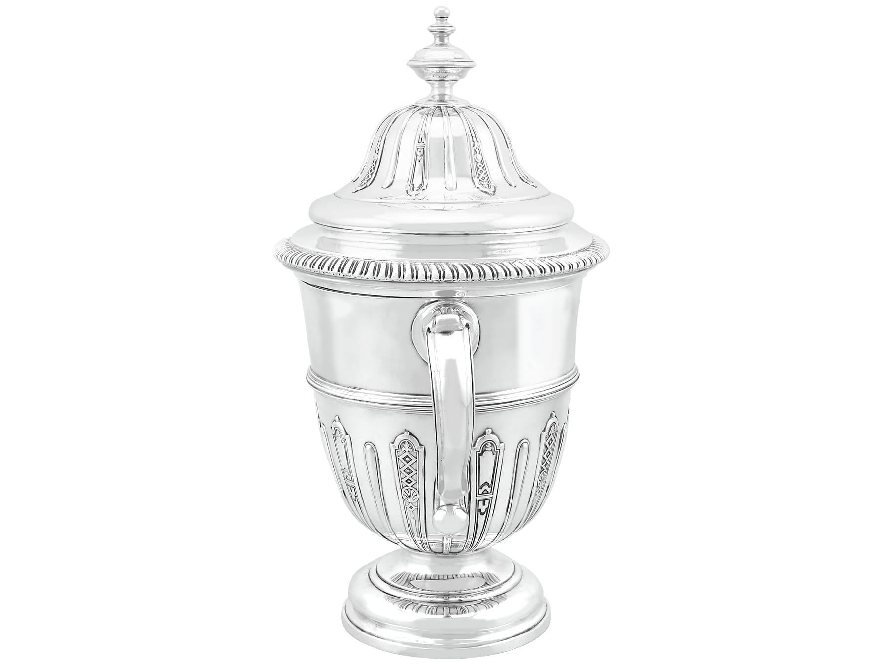 An exceptional, fine and impressive antique Victorian English sterling silver presentation cup and cover; an addition to our silver presentation collection

This exceptional antique Victorian sterling silver trophy cup has a plain bell shaped form