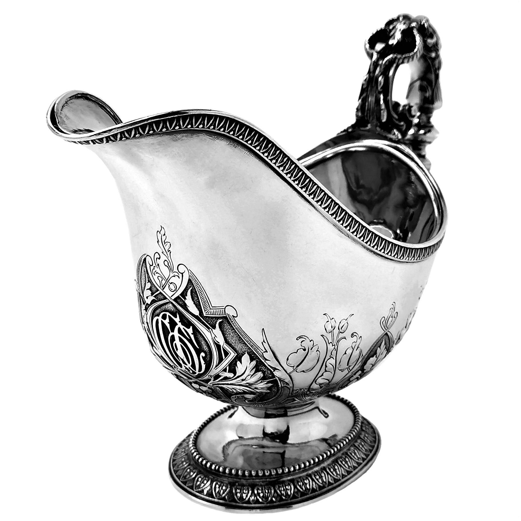 An impressive Antique Victorian Solid Silver Sauce Boat with removable Solid Silver Liner, This Gravy Boat is of substantial size and good weight. It features a magnificent decorative handle cast with a horned face and scroll decorations. The Body