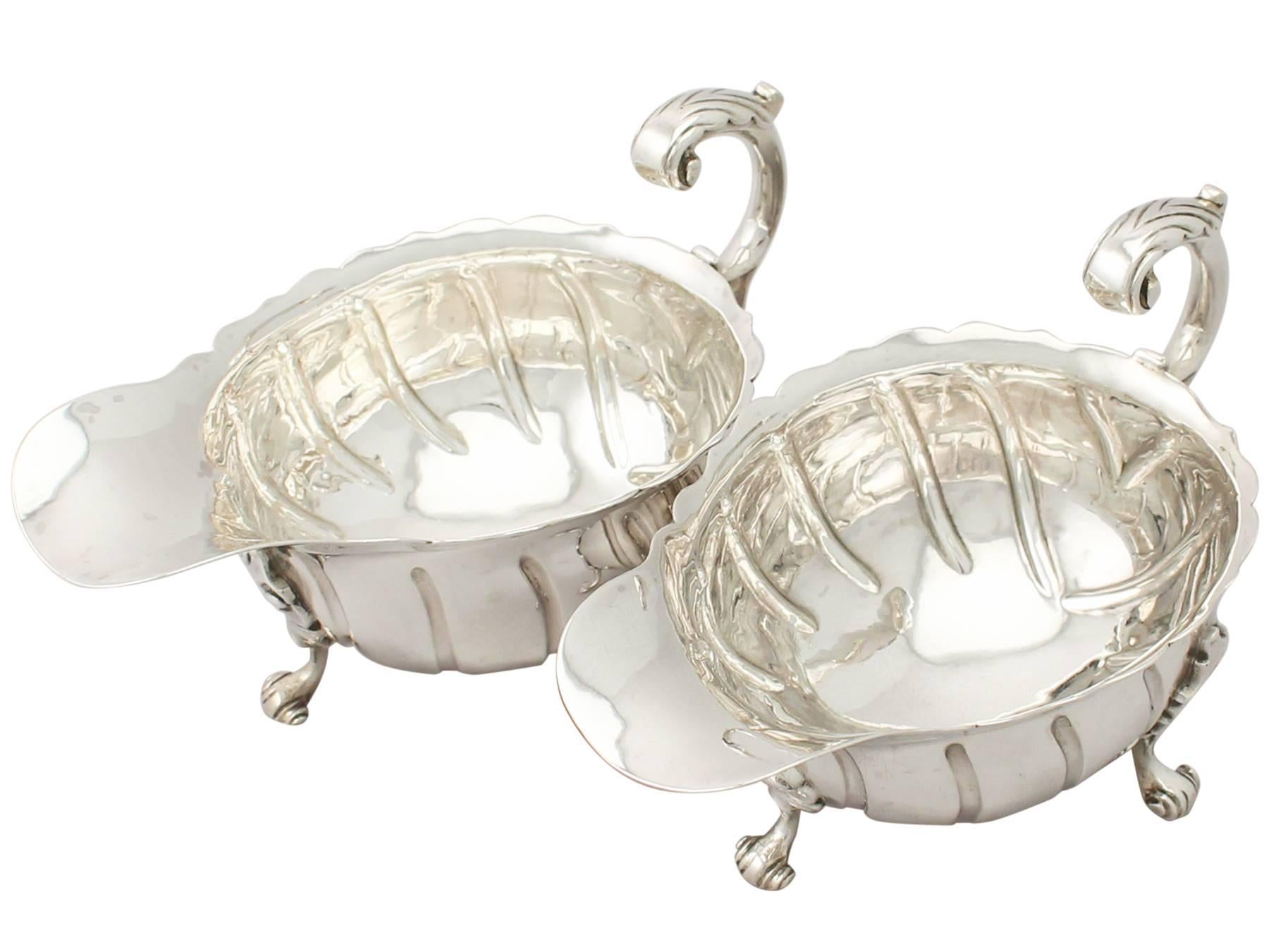 A fine and impressive pair of antique Victorian English sterling silver sauceboats; an addition to our dining silverware collection.

These fine antique Victorian sterling silver sauceboats have an oval rounded form.

The surface of each silver