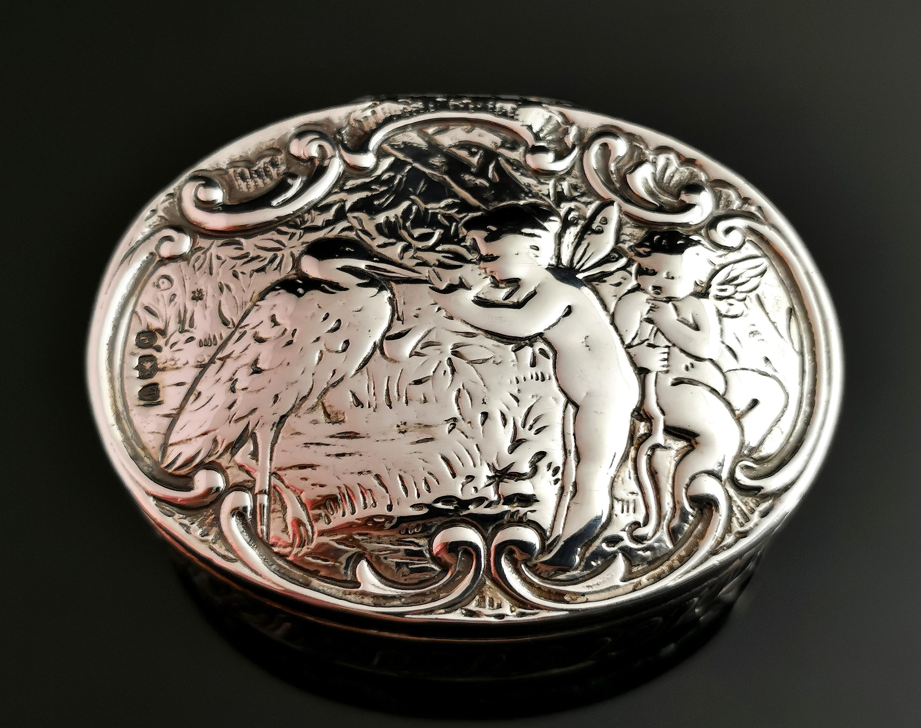 A beautiful antique, Victorian sterling silver snuff box.

Oval shaped box with decorative shaped and engraved sides, the lid of the box features a pretty scene of two fairies and a stork in woodland.

Very fine box with great attention to