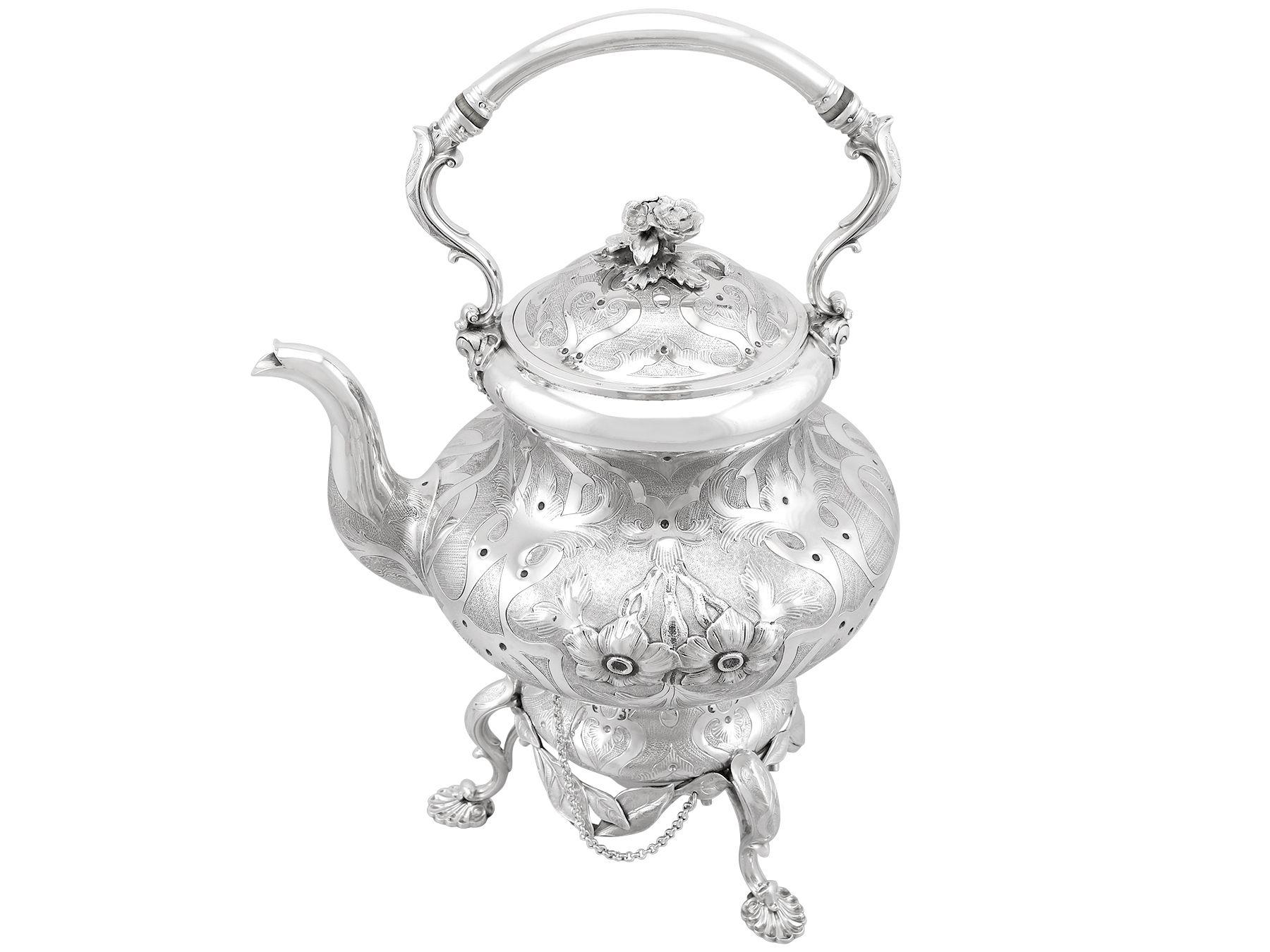 This magnificent antique Victorian sterling silver spirit kettle has a baluster shaped form.

The surface of the kettle is embellished with exceptional chased floral designs, incorporated within plain impressive interlacing foliate designs, all on a