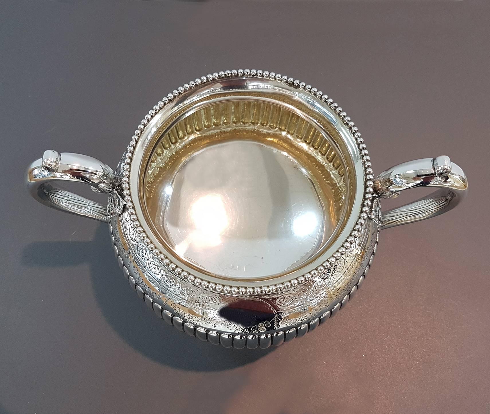 Antique large Victorian sterling silver sugar bowl, having a round body with hand-chased half-fluted decoration, and sitting on a flat base. Made by John Aldwinckle & Thomas Slater, of London in 1888.
The dimensions of this fine handmade antique