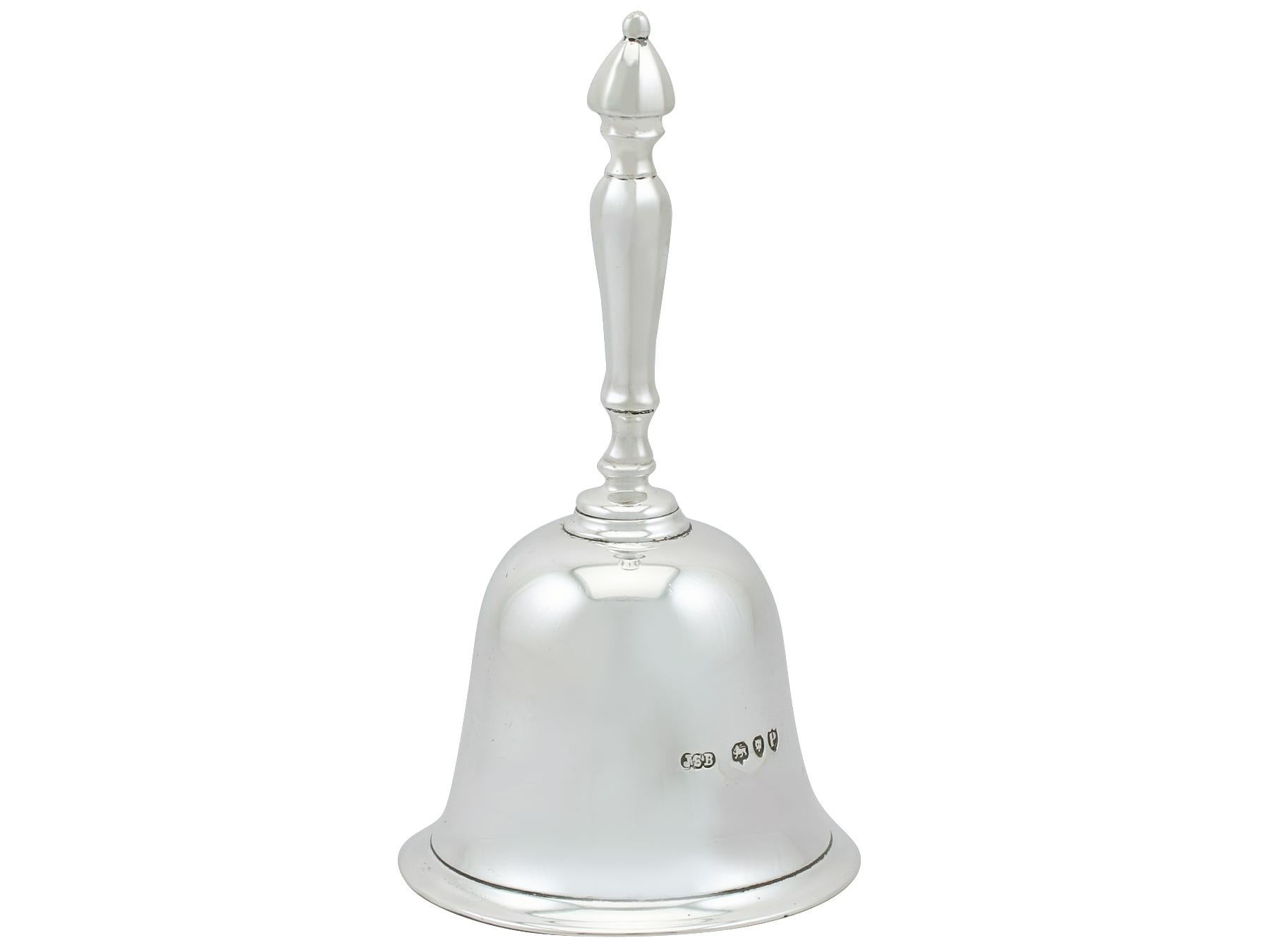 An exceptional, fine and impressive antique Victorian English cast sterling silver table bell; an addition to our range of ornamental silverware.

This exceptional antique Victorian cast sterling silver table bell has a plain bell shaped