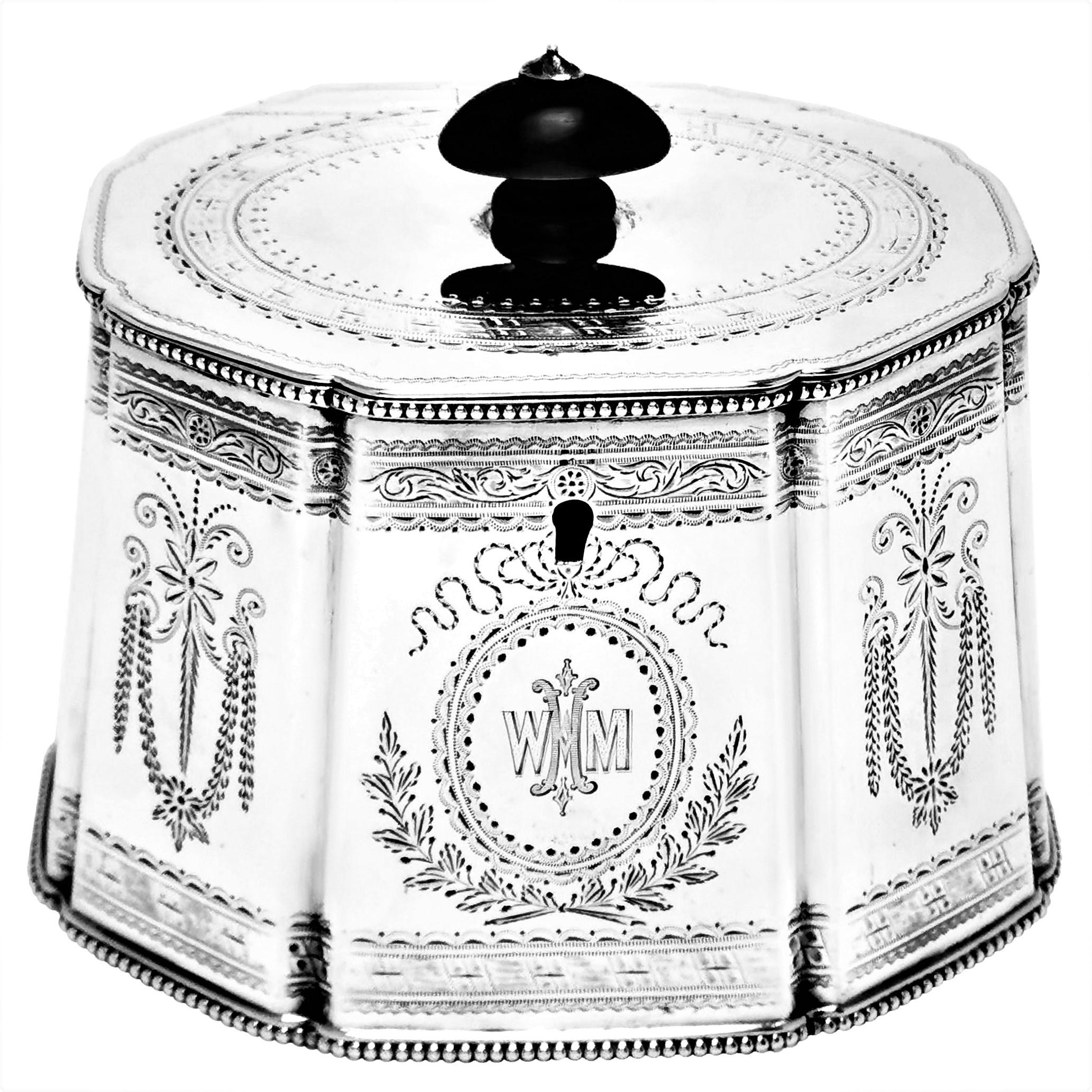 A lovely Antique Victorian Sterling Silver Tea Caddy in an elegant tapered octagonal shape. The panels of the body and the hinged lid are embellished with beautiful bright cut engraved patterns and an engraved monogram.

Made in London, England in