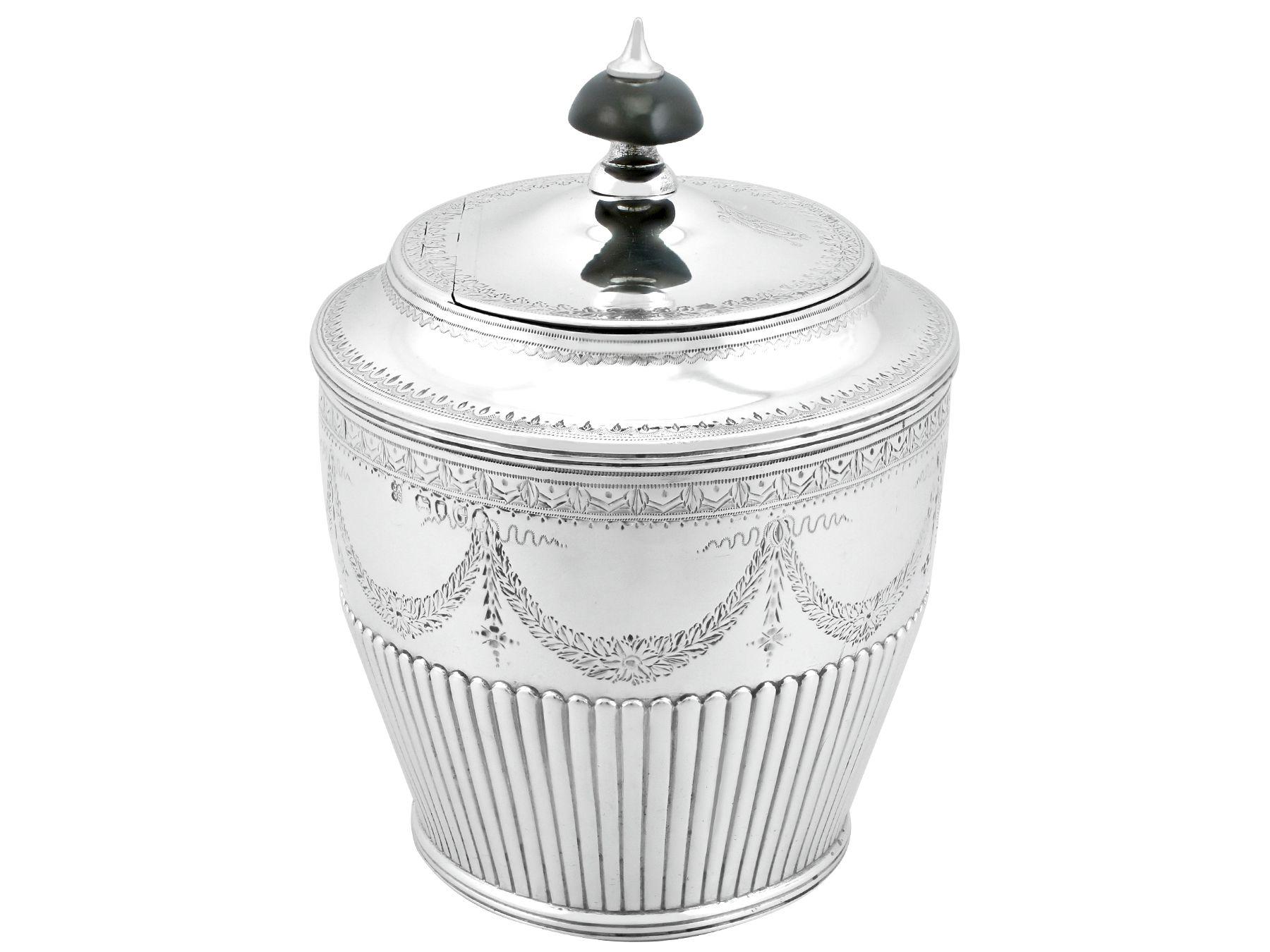 An exceptional, fine and impressive antique Victorian English sterling silver tea caddy; an addition to our silver teaware collection.
This exceptional antique Victorian sterling silver tea caddy has an oval shaped form.

The surface of this fine