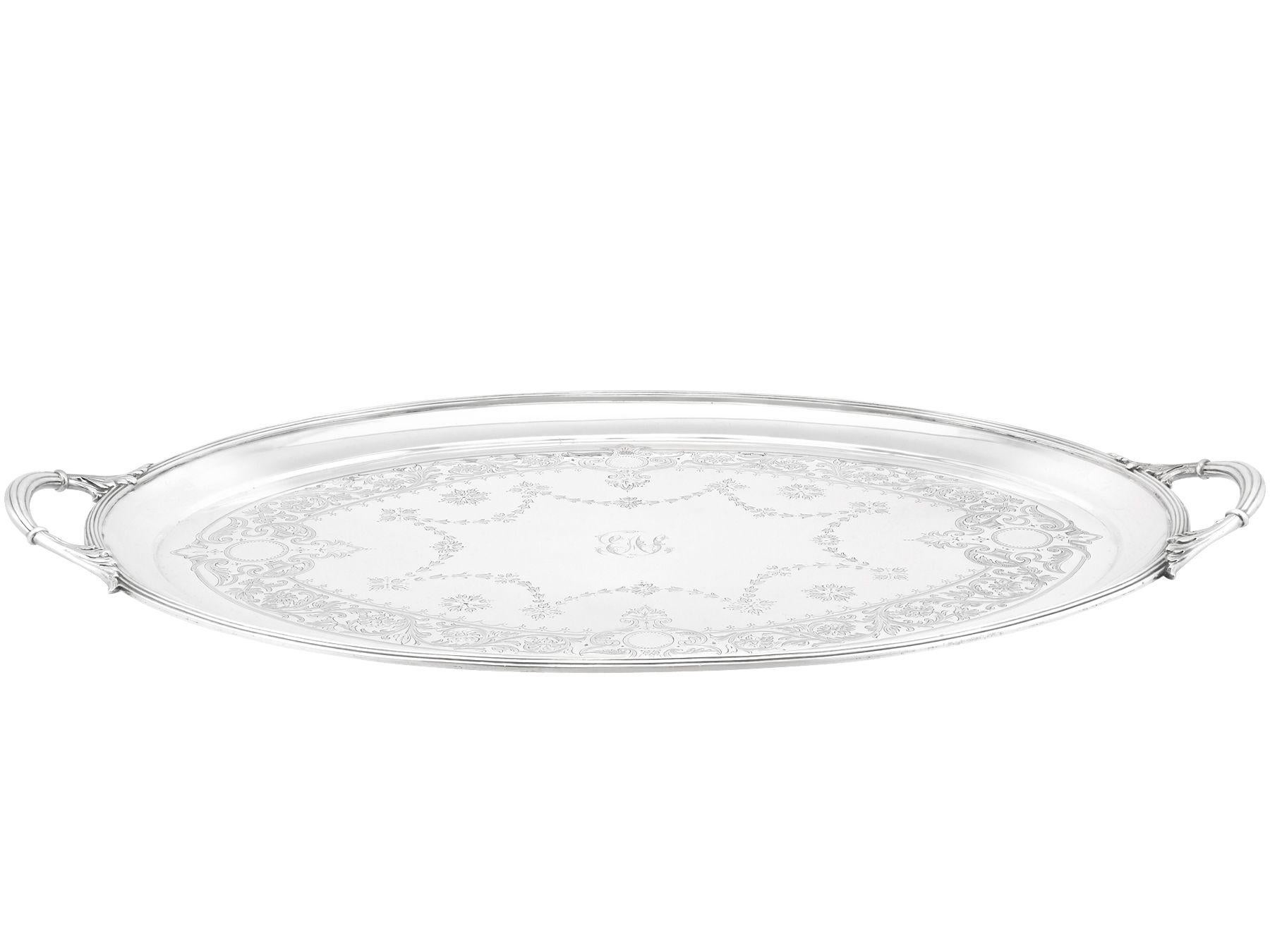 An exceptional, fine and impressive antique Victorian English sterling silver engraved tea tray made by Walter & John Barnard; an addition to our silver tray collection.

This exceptional antique Victorian sterling silver tray has an oval form.

The