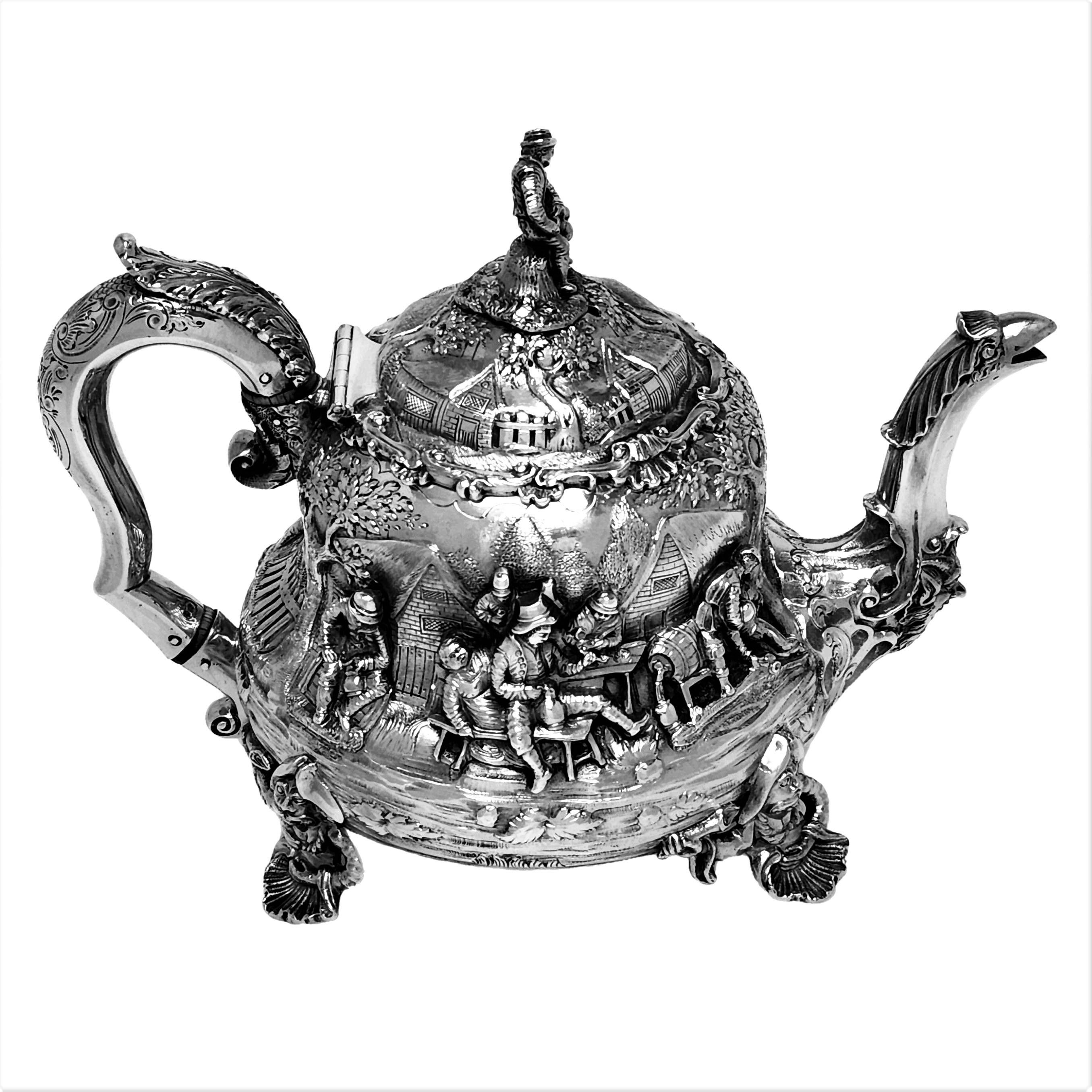 A magnificent Antique Victorian Silver Teapot in a pear shape and featuring ornate chased and applied images of people revelling and drinking in the style of the Dutch Painter David Teniers the Younger, who known for his detailed depictions of