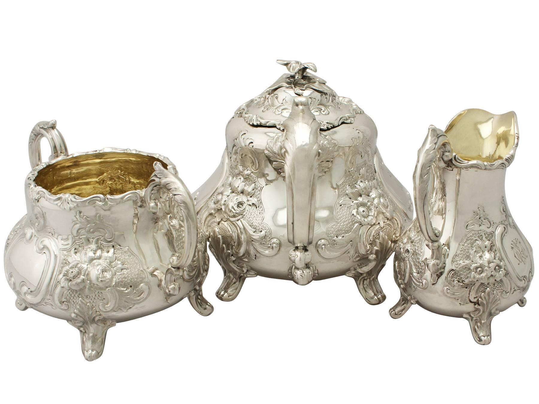 An exceptional, fine and impressive antique Victorian English sterling silver three-piece tea service / tea set; part of our silver teaware collection.

This fine antique Victorian sterling silver three-piece tea service consists of a teapot,