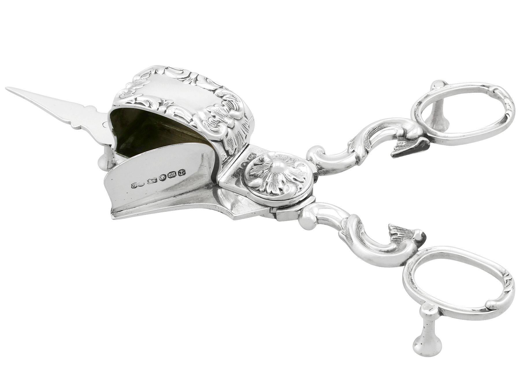 An exceptional, fine and impressive pair of antique Victorian English sterling silver wick trimmers; an addition to our silver flatware collection.

This exceptional pair of antique Victorian sterling silver wick trimmers has a hinged scissor