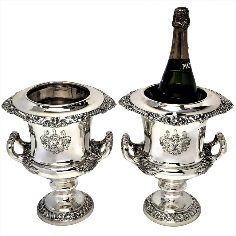 A pair of impressive Antique Victorian Solid Silver Wine Coolers with magnificent  acanthus leaf handles. The Rim of the cooler and the spread foot are decorated with elegant classic shell and gadroon patterns. Each Cooler has a large armorial