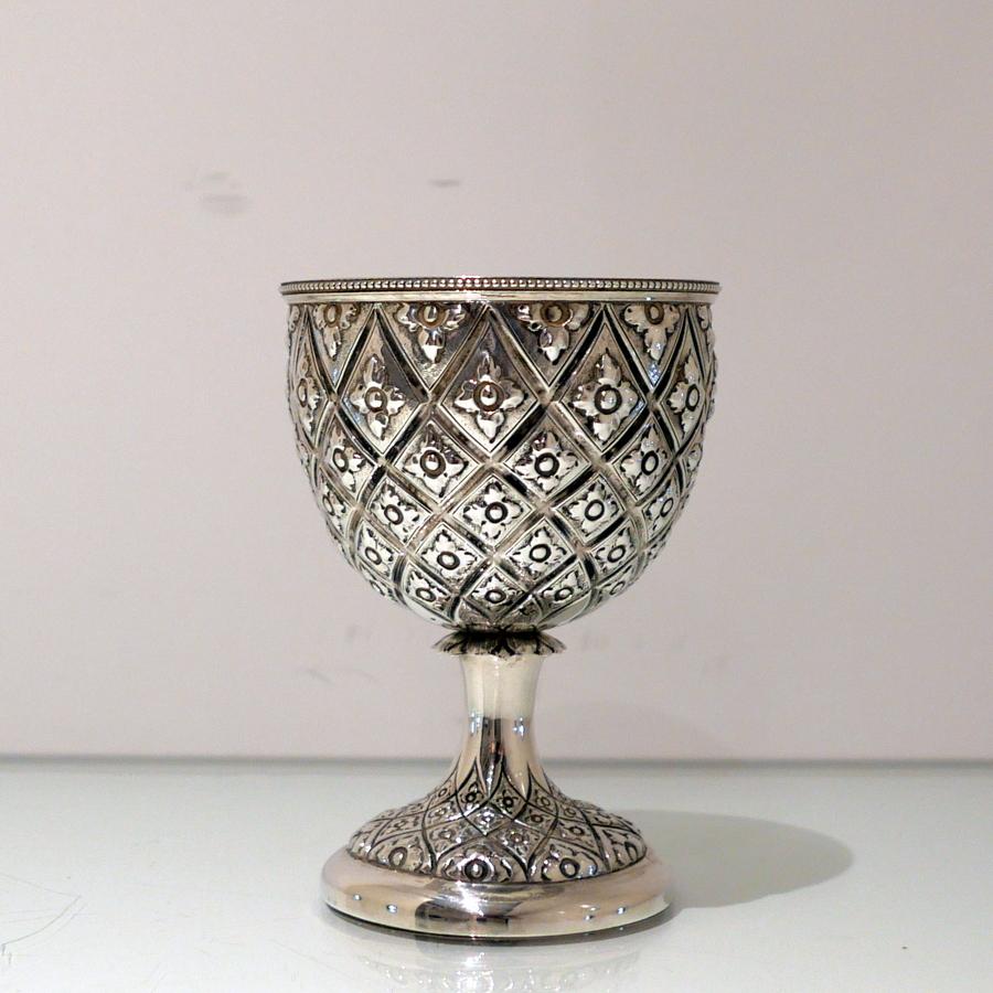 A very elegant Victorian silver Abercrombie patterned wine goblet decorated with diamond patterns framing an elegant floral motif. The rim of the goblet has additional bead wiring for highlights.

 Weight: 8.3 troy ounces/259 grams

Measures: