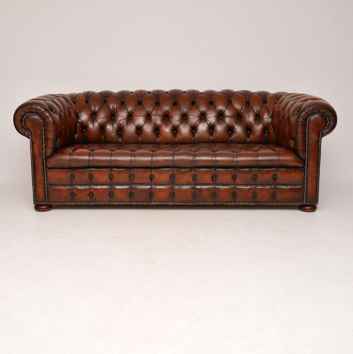 Antique three-seat Victorian style deep buttoned leather Chesterfield sofa dating from circa 1930s-1950s period sitting on flat bun feet. It’s in good original condition and has loads of character. The leather doesn’t have any tears or holes. There