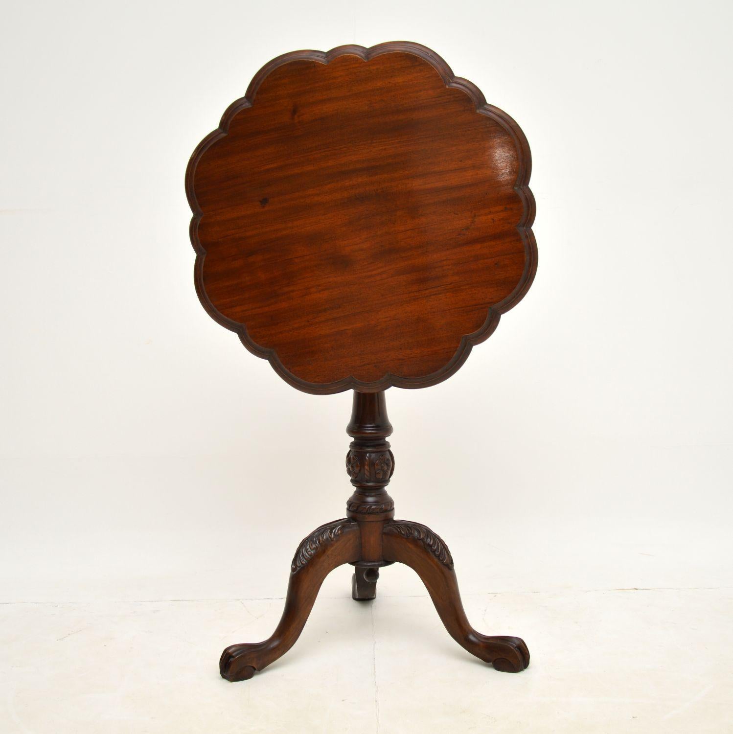A stunning antique Victorian flip top side table in solid mahogany, with a spinning top & dating to around the 1850 period.

The shape is very unusual and really gorgeous. It has a flower shaped top, sitting on a birdcage support on top of a