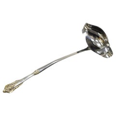 Cuchara de servir antigua de estilo victoriano chapada en plata y con repujado dorado