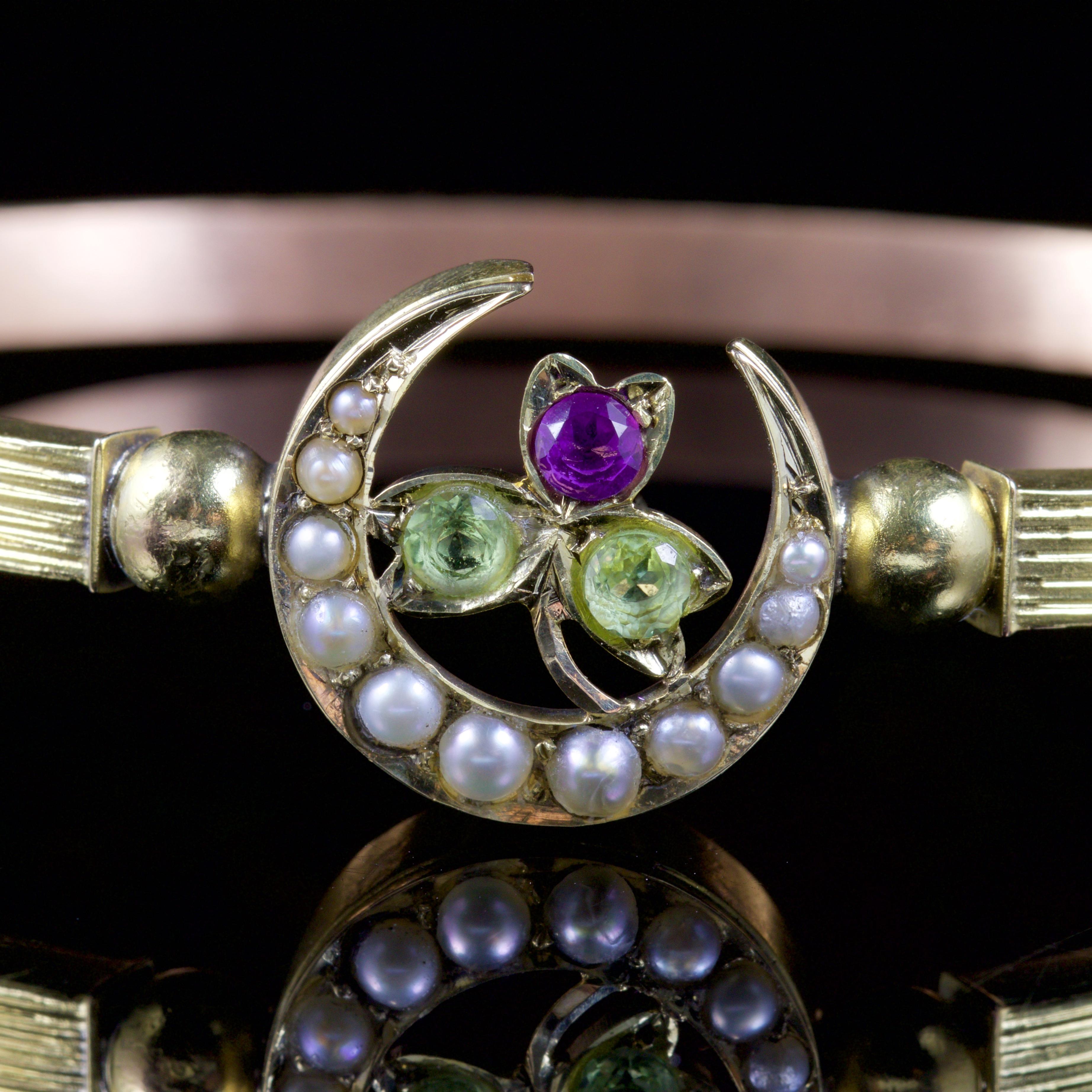 This Victorian Suffragette Bangle is set in 18ct Yellow Gold, Circa 1900.

An elegant Pearl crescent and an Amethyst, Peridot flower/shamrock adorns this fabulous Suffragette bangle.

Suffragettes liked to be depicted as feminine. Their jewellery