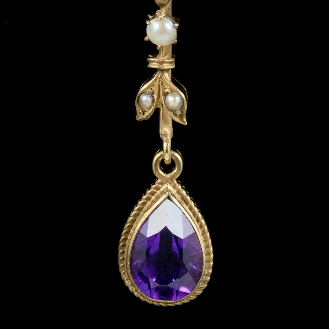 These fabulous antique Suffragette drop earrings are Victorian, Circa 1900. 

Each earring is adorned with a square cut green Peridot, three creamy Pearls and a beautiful Violet Amethyst dropper which is 1.75ct.

Suffragettes liked to be depicted as
