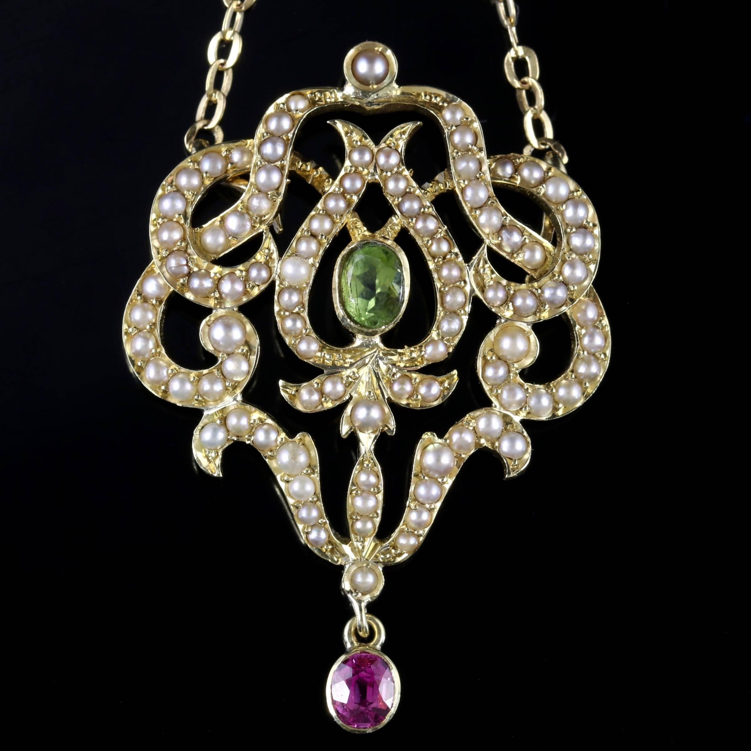 This truly beautiful Victorian 15ct Gold Suffragette drop Pendant is Circa 1900. 

The pendant is adorned with lustrous Pearls which are set into the floral style gallery, it is adorned with a Pink Sapphire on the bale, which leads down to the