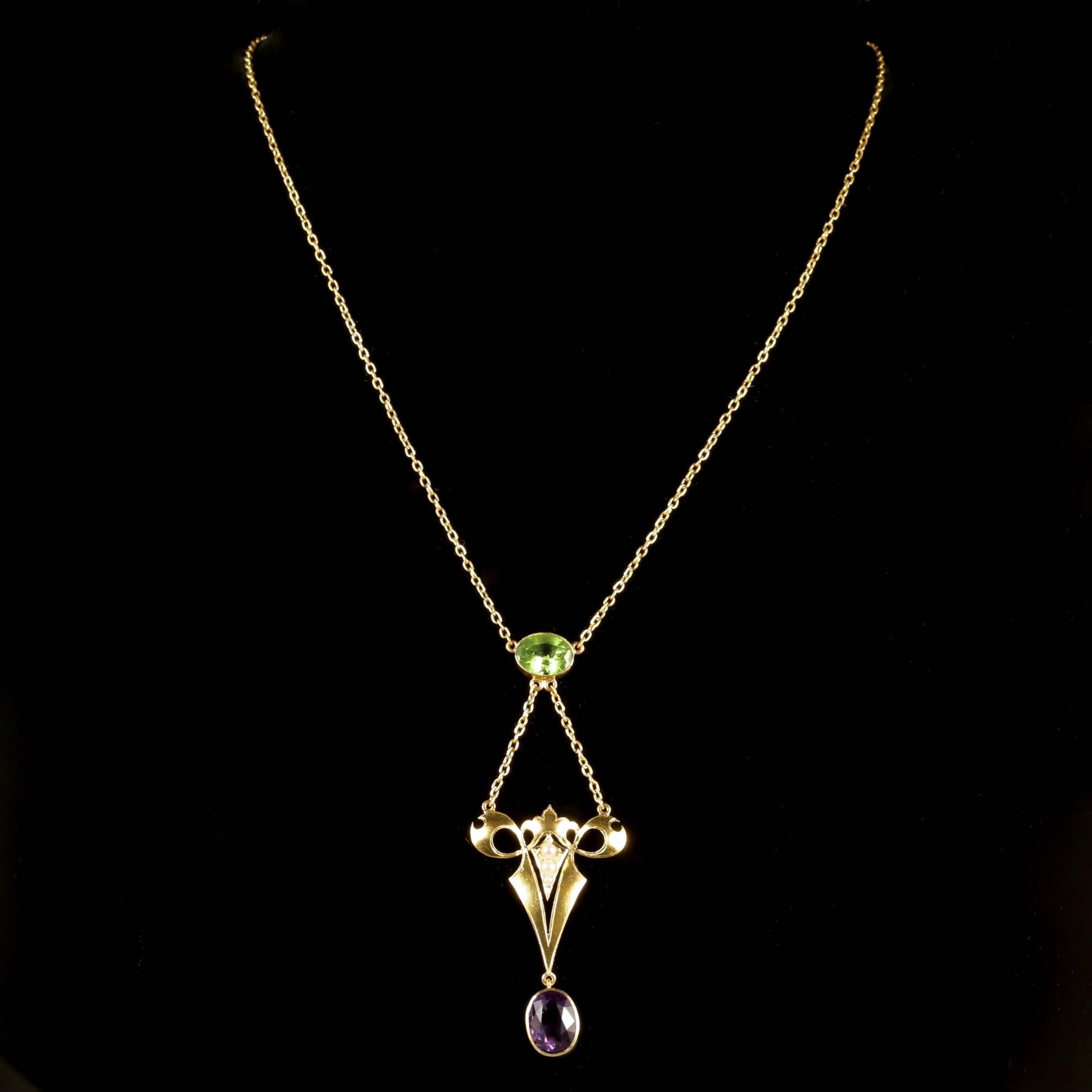 This fabulous 15ct Yellow Gold Victorian Suffragette necklace is Circa 1900.

The beautifully designed necklace is adorned with a Peridot, leading down to 3 Pearls in a Gold gallery, and a Amethyst dropper. This combination of gemstones represent