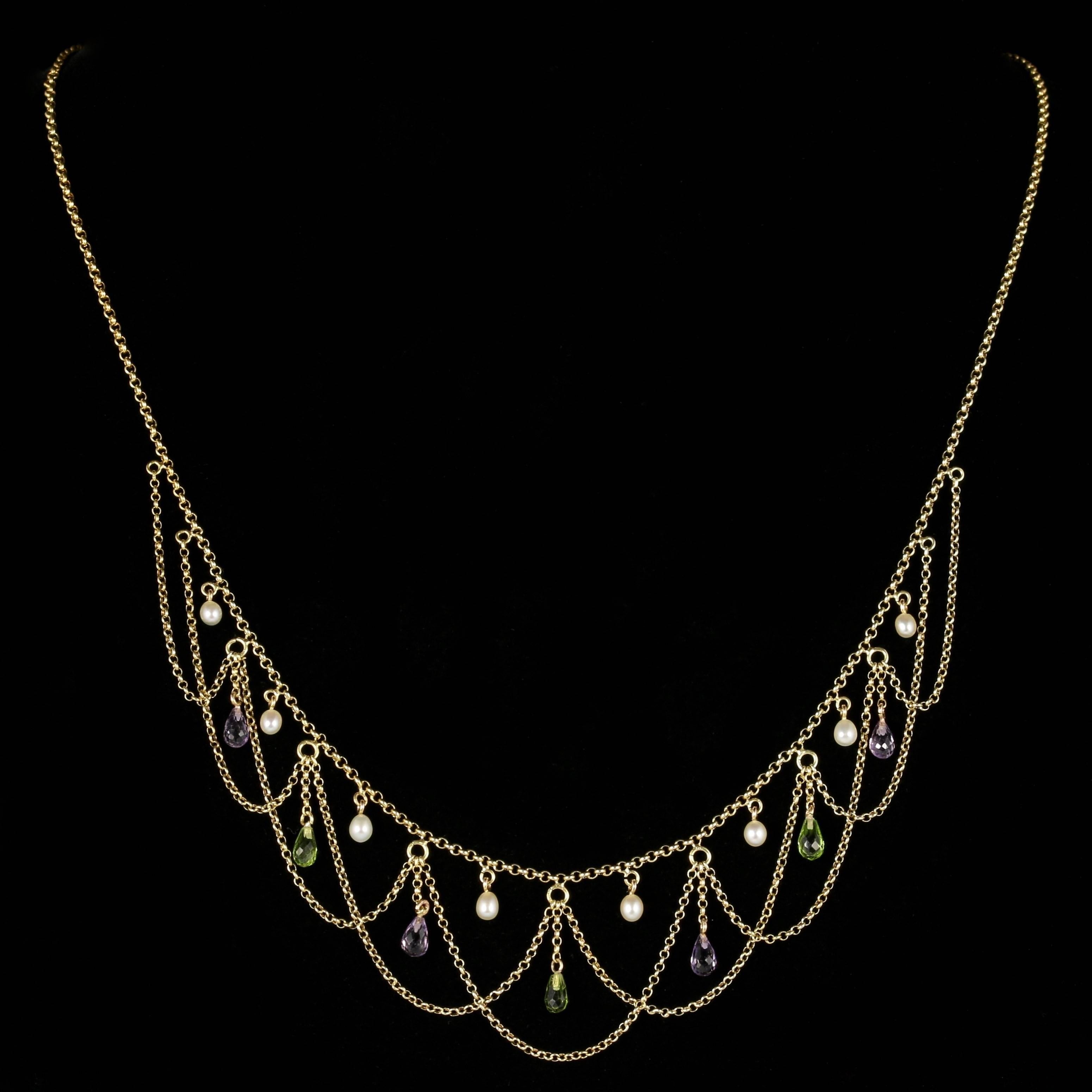 For more details please click continue reading down below...

This genuine antique Victorian 15ct Yellow Gold Suffragette necklace is Circa 1900.

Set with beautiful detail, and Amethyst, Peridot and Pearl stones amongst a draping design.

Emmeline