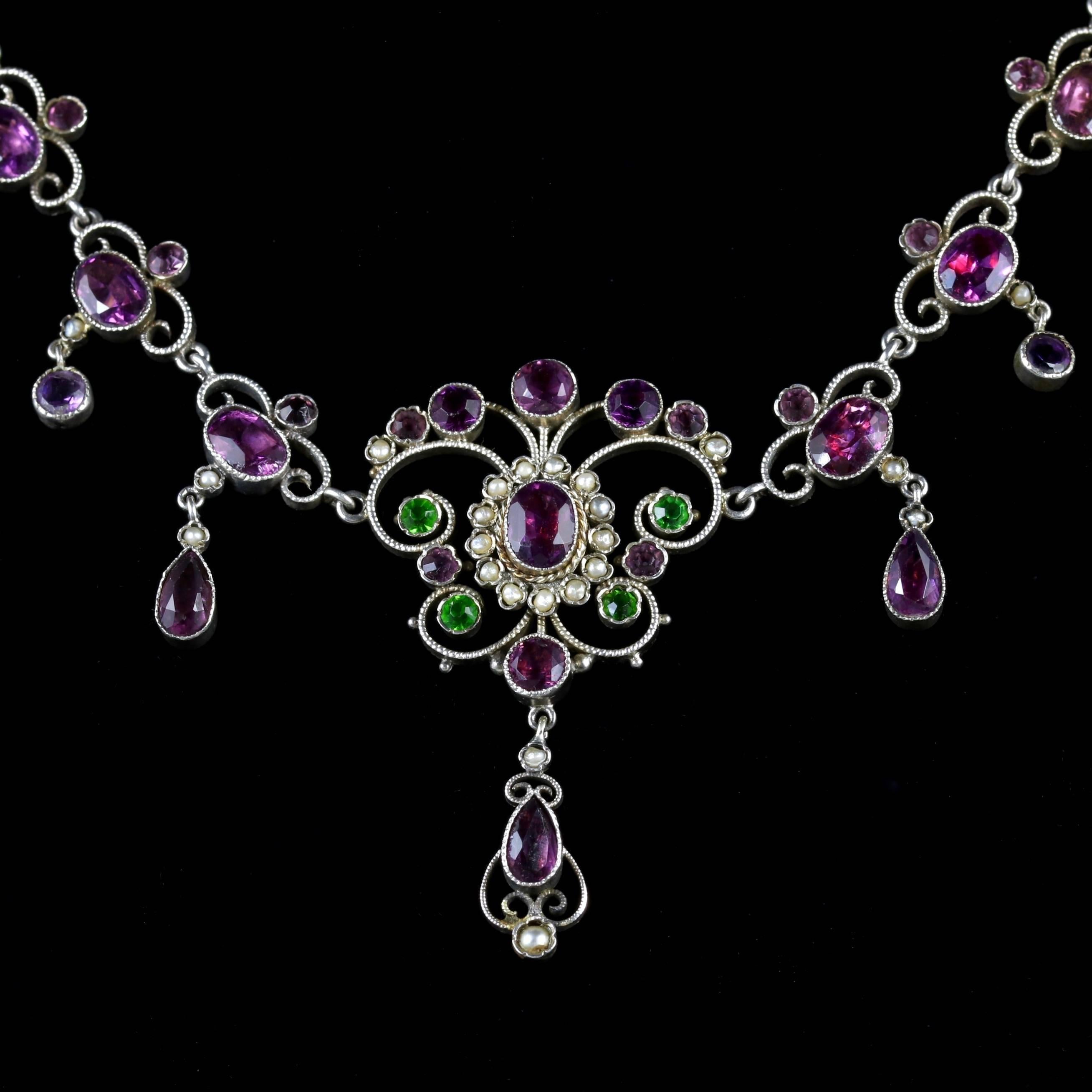 This Antique Victorian Silver Suffragette Paste Stone and Pearl necklace is beautiful, Circa 1900.

The necklace is complimented by a mixture of purple and green Paste Stones, with lustrous Pearl nested in-between, which is all original to the