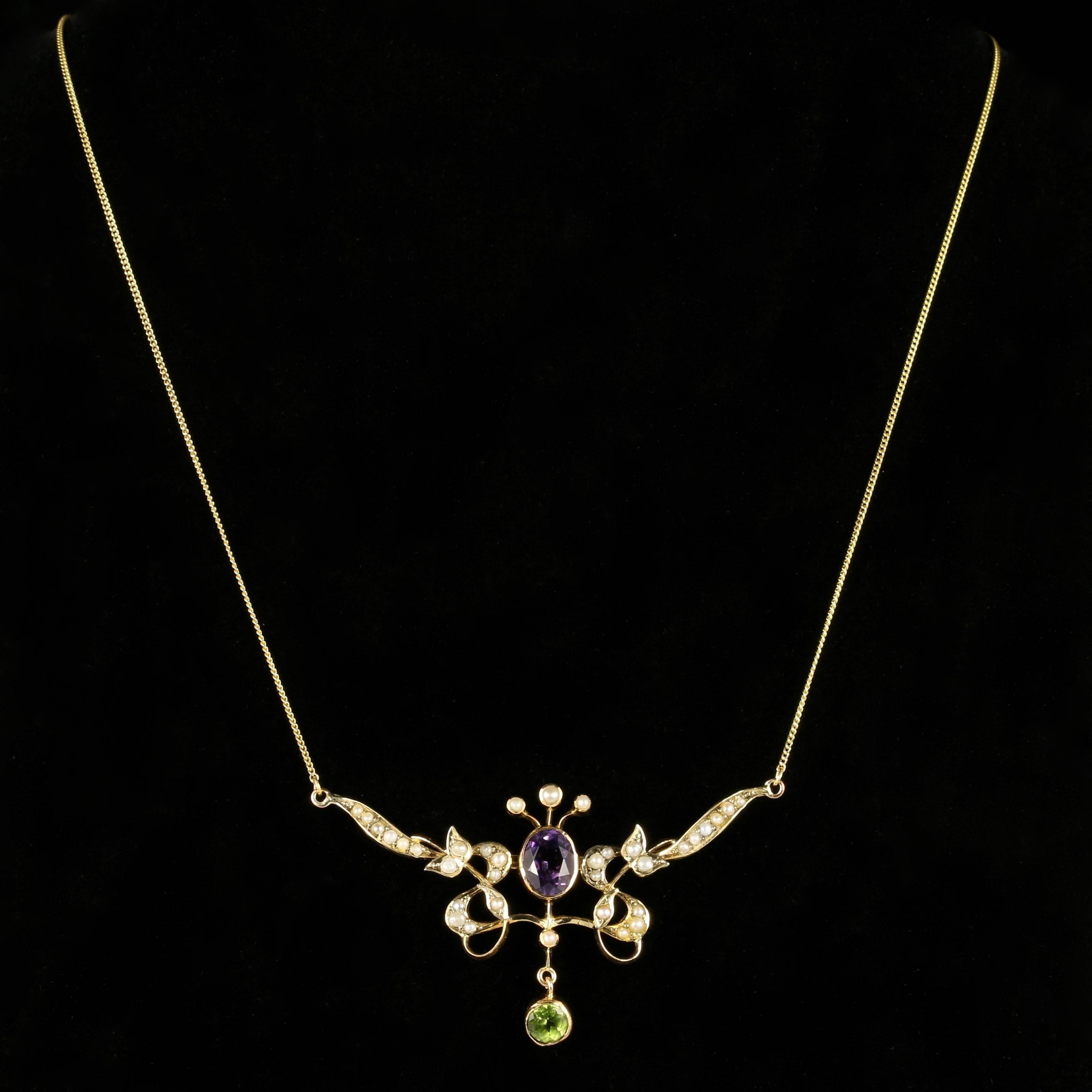 For more details please click continue reading down below...

This fabulous Antique 9ct Yellow Gold Victorian Suffragette necklace is Circa 1900.

The beautifully designed Pendant is adorned with Violet Amethyst’s, green Peridots and lovely cream