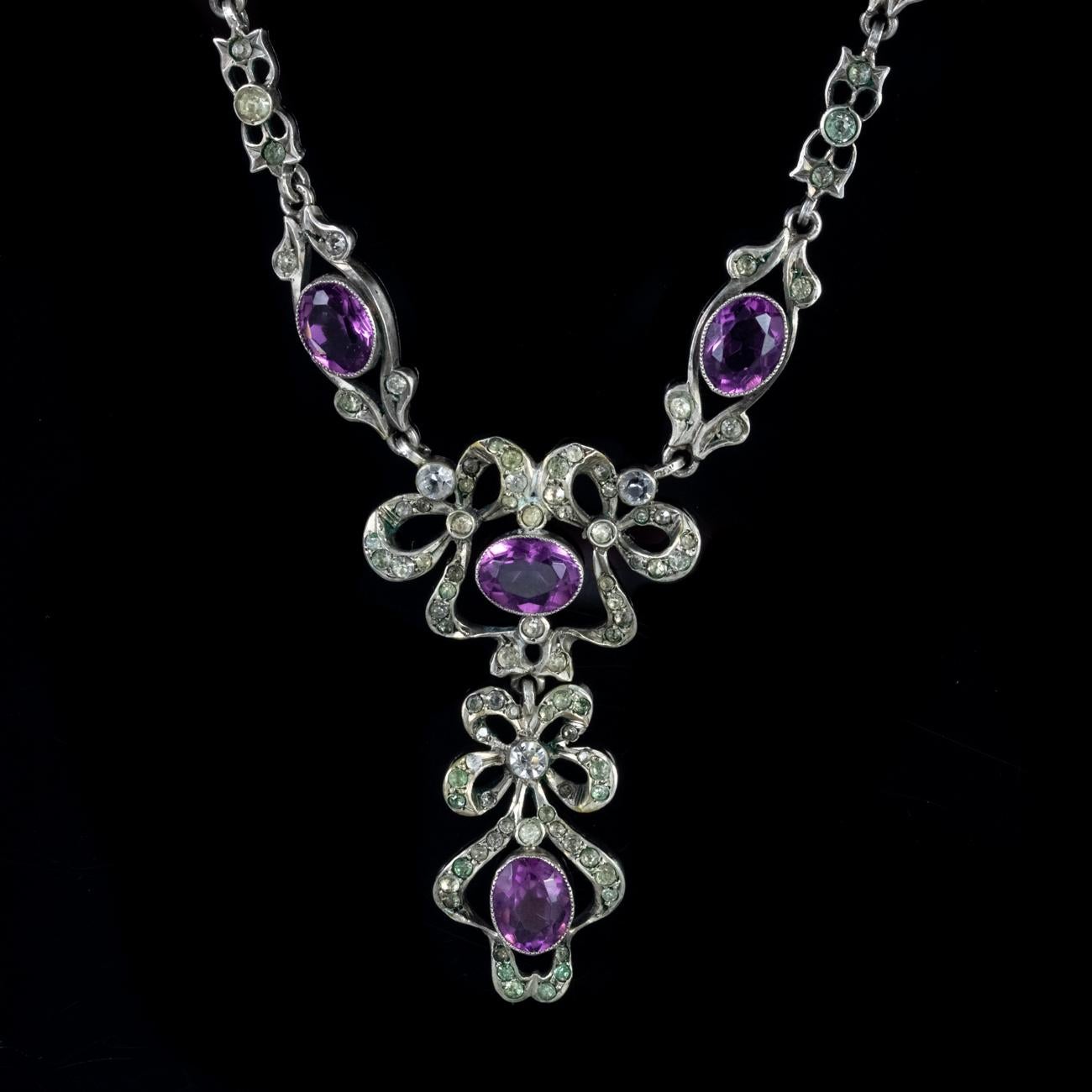 This beautiful Antique Victorian Suffragette necklace has been commissioned in Silver and set with an array of coloured Paste stones. The larger Paste stones weigh approx. 1.75ct each and are purple, with the smaller stones being white and