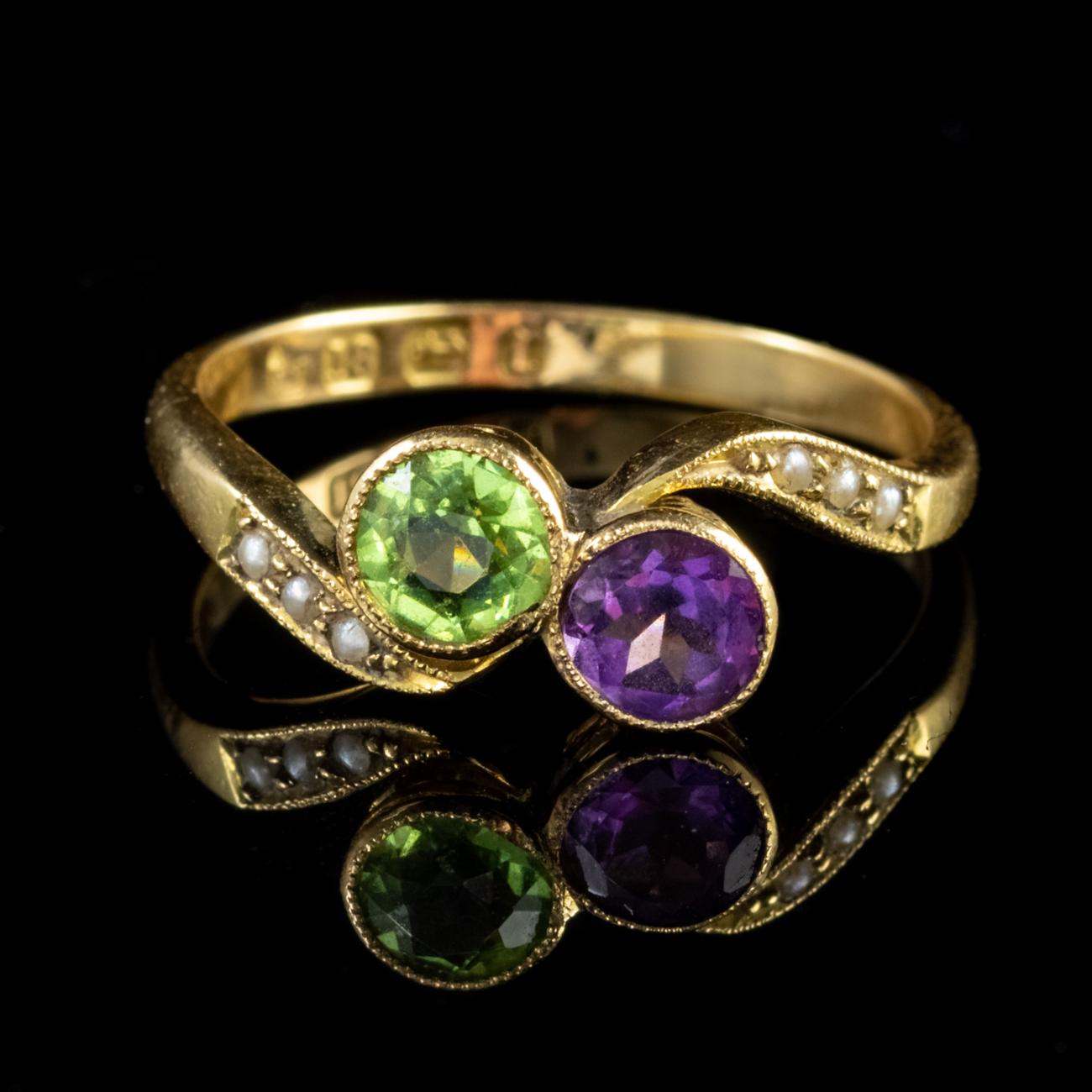 This beautiful Antique Victorian Suffragette ring has been modelled in 18ct Yellow Gold and features a fantastic twist design. The ring is set with an Amethyst and a Peridot, both of which weigh approx. 0.60ct each and are flanked by an array of