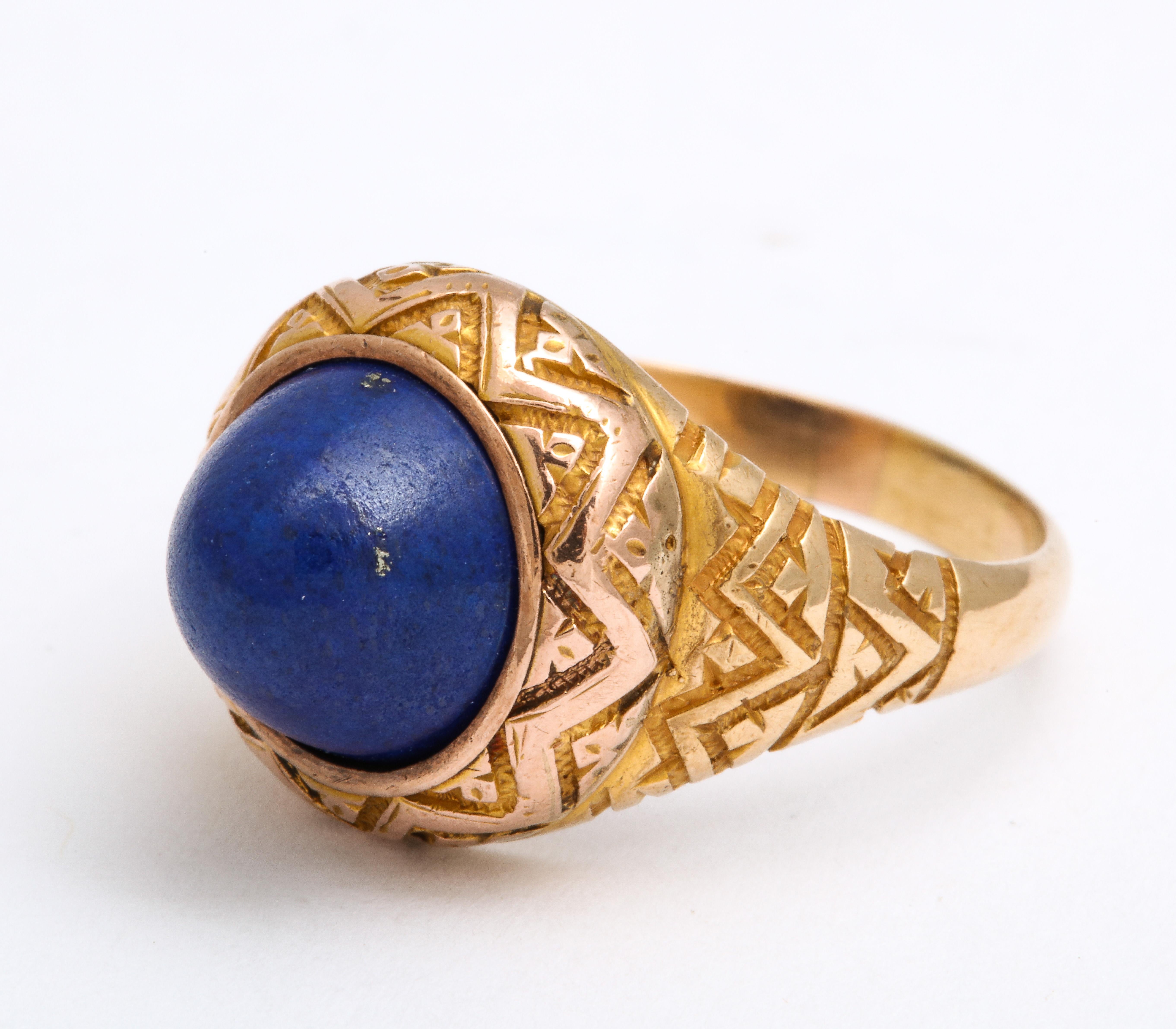 A two carat plus dome of Lapis Lazuli has characteristic flecks in the stone and looks like the clear blue of the night sky. The ring cut is know as a sugarloaf as it rises upward from the shank. A stunning geometric shank in 14 Kt.emphasizes the