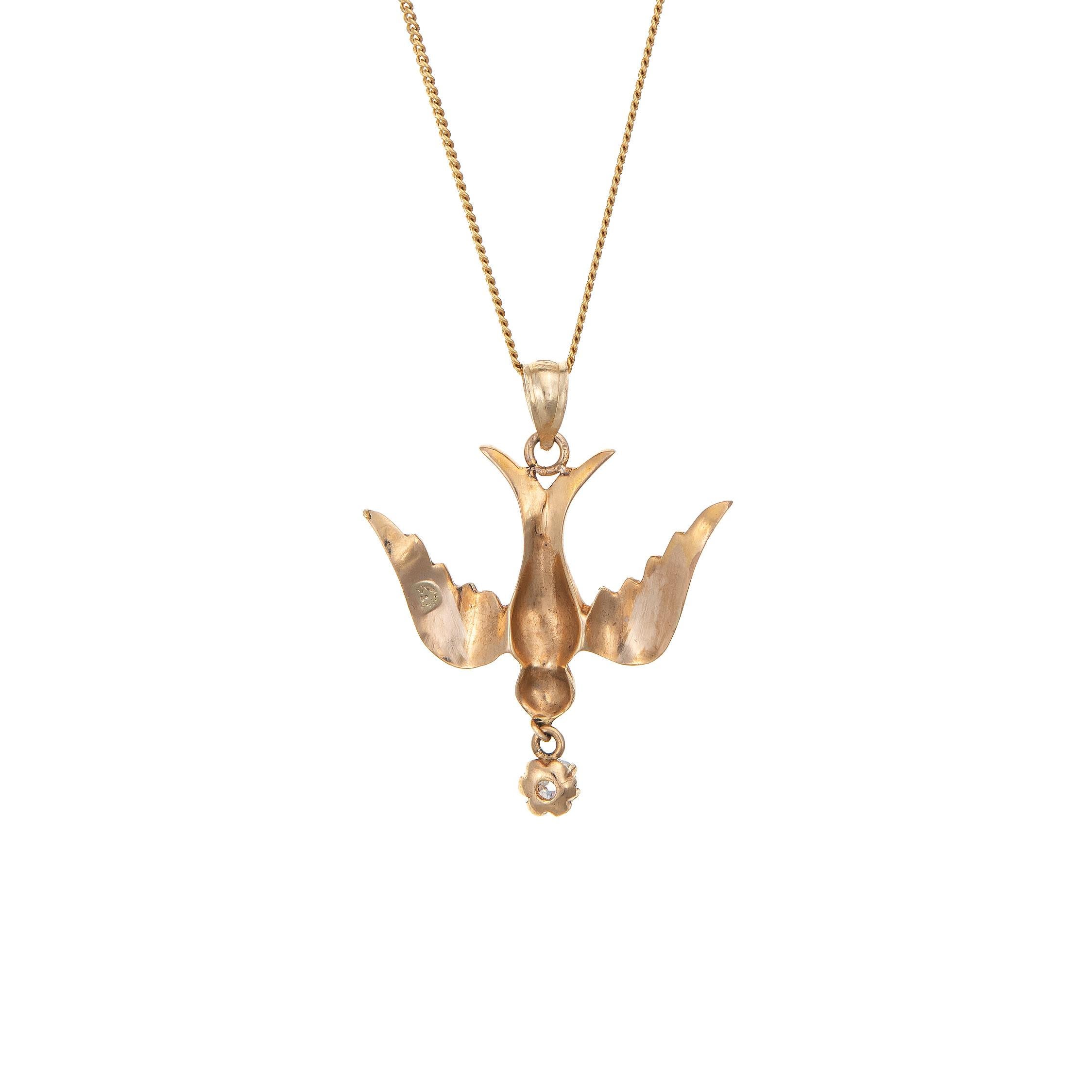 Elegant and finely detailed antique Victorian swallow pendant & necklace (circa 1880s to 1900s), crafted in 14k yellow gold. 

One estimated 0.15 carat old mine cut diamond is estimated at J-K color and SI2 clarity. The seed pearls measure (average)