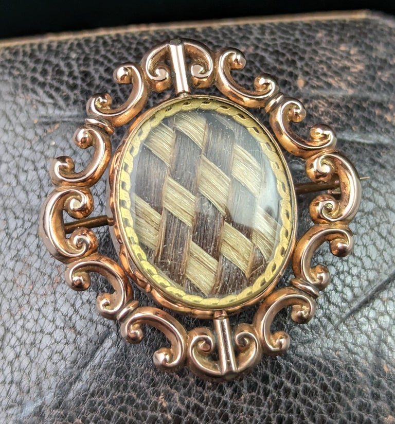 There is something quite special about this antique Mourning brooch, it may be the neatly woven chequer board two colour hairwork, the swivel action or the elaborate scrolling gold frame.

Maybe it's all of those things and more, what do you love