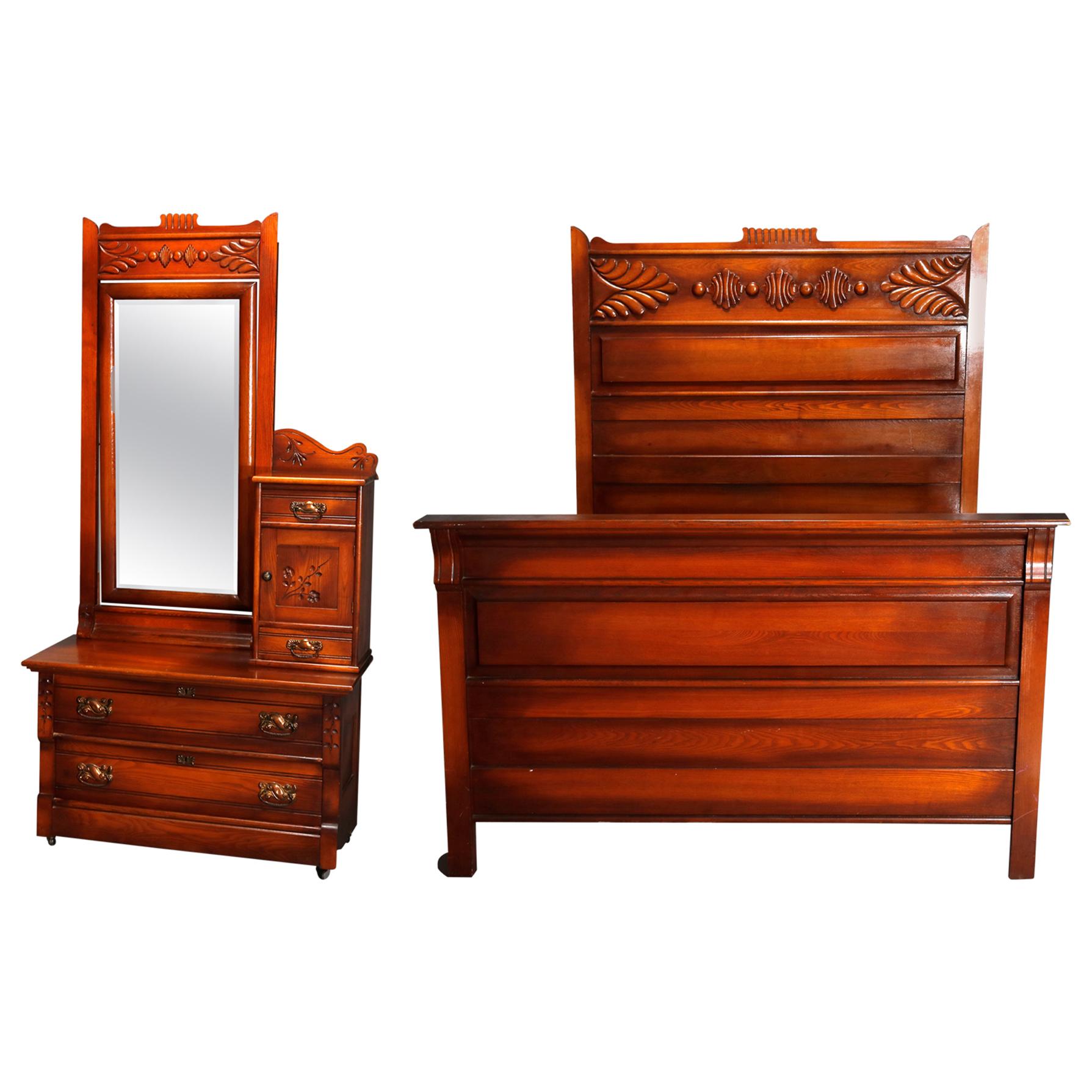An antique Victorian Eastlake bedroom suite offers oak construction with carved stylized foliate elements and includes full size tall back bed, dressing bureau with long mirror and bonnet box, and wash stand, circa 1890.

Measures: Bed frame- 78