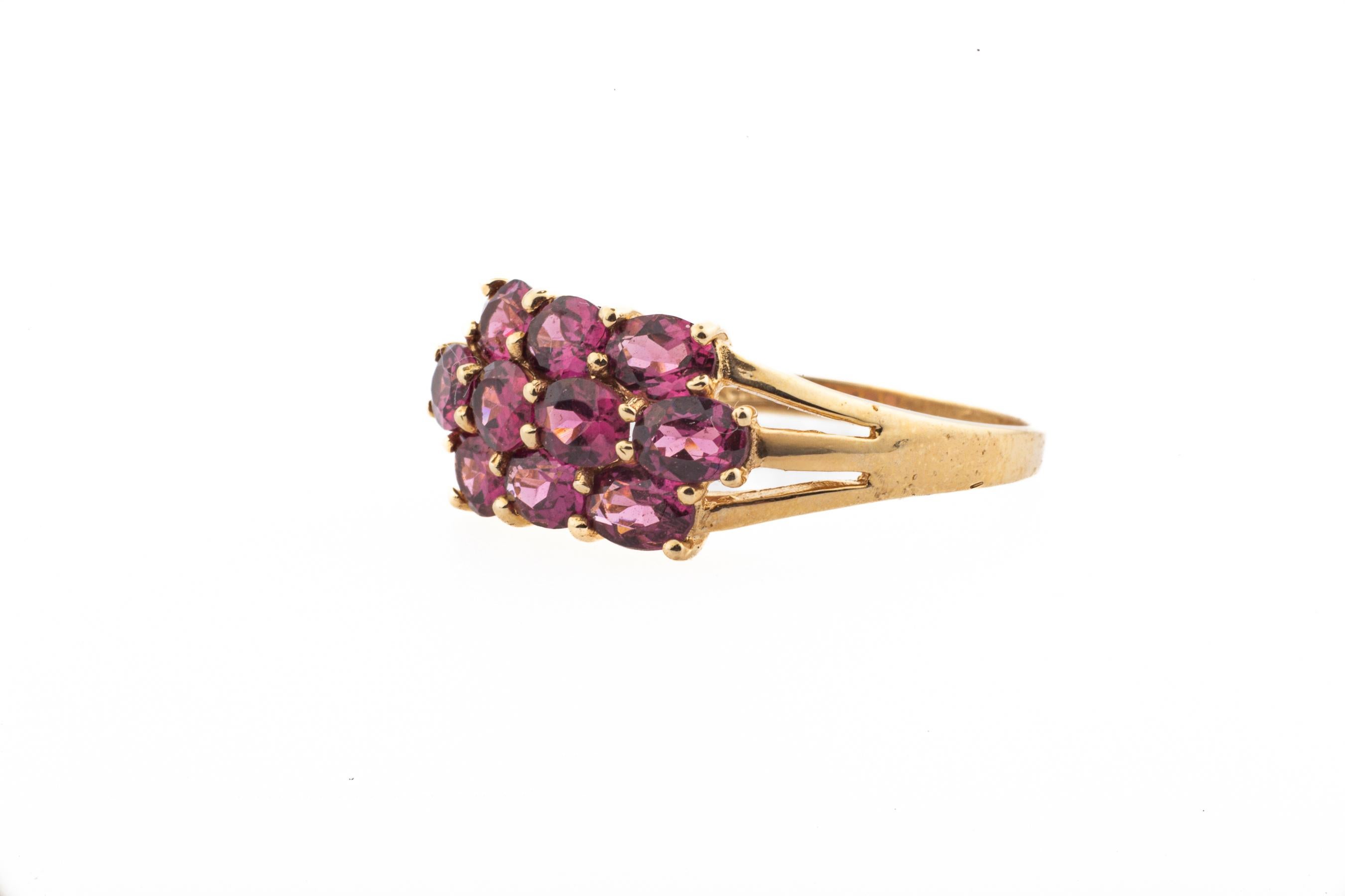 A victorian garnet ring with brilliant, sparkling cherry color and a pink under glow. Made in c.1890, the ring is American made in 14 Kt gold. The way the jeweler set the stones makes the prongs ornamental and this makes the ring more striking.