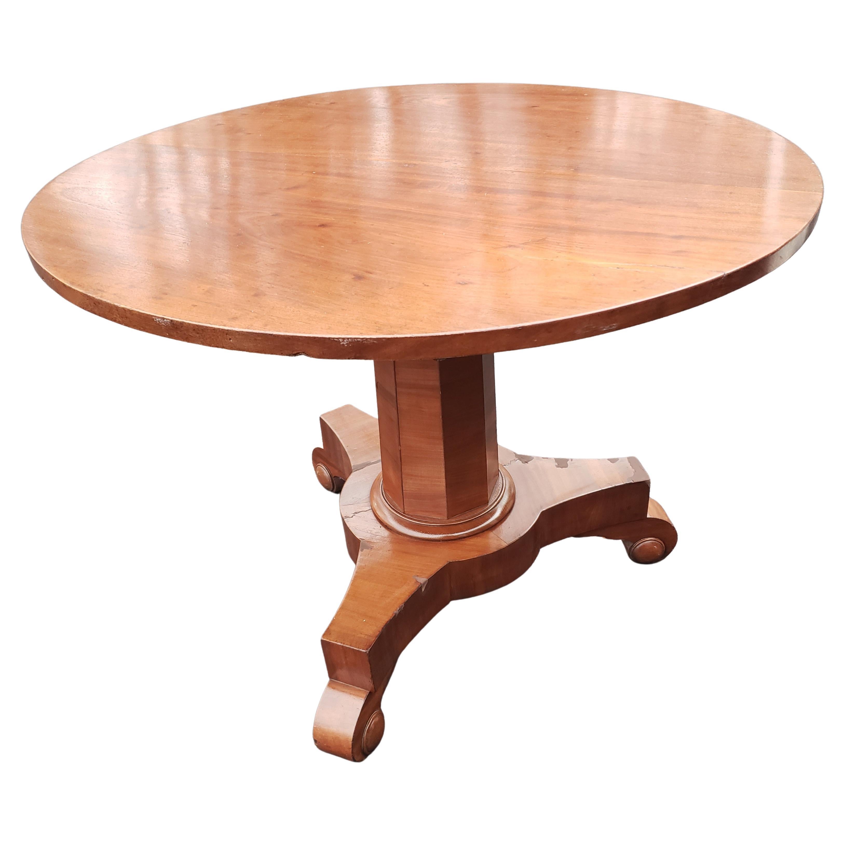 An Antique Victorian circular Tilt Top breakfast table. Delightful looking quality made table with three pronged foot and central pedestal.

Offered in used vintage condition with signs of age, wear in a couple of spots on feet, as might be