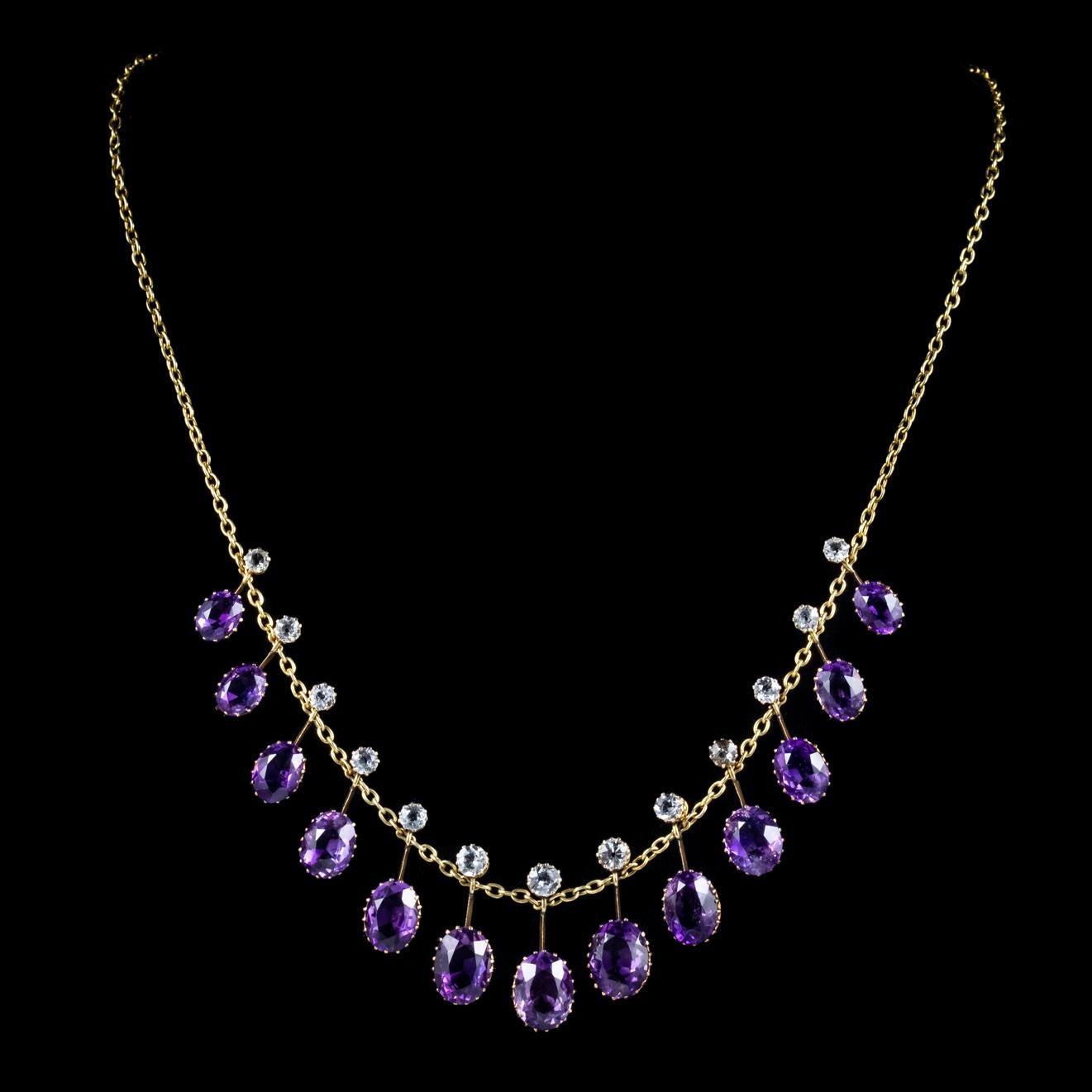 A spectacular antique Victorian necklace featuring a line of fabulous droppers each crowned with a white Topaz stone and a larger Amethyst which graduate in size along the piece. 

Amethyst has been highly esteemed throughout the ages for its