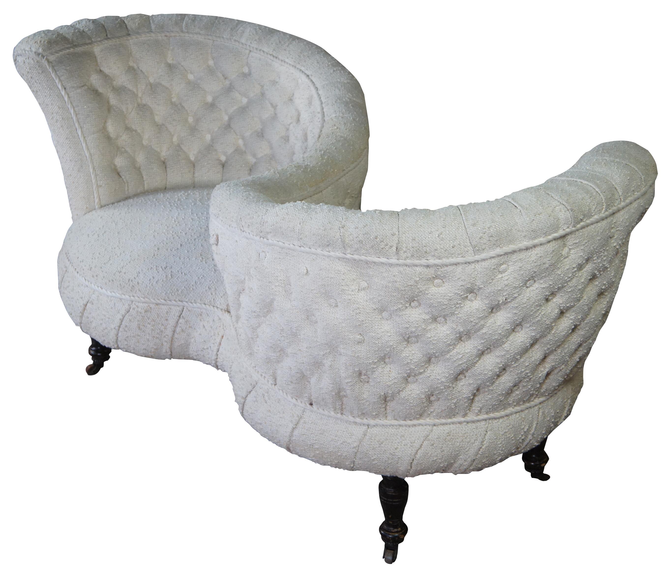 A magnificent Victorian era Tete-A-Tete. Upholstered in a heavy off white tufted fabric. The bench is supported by five turned walnut legs with casters.
    
