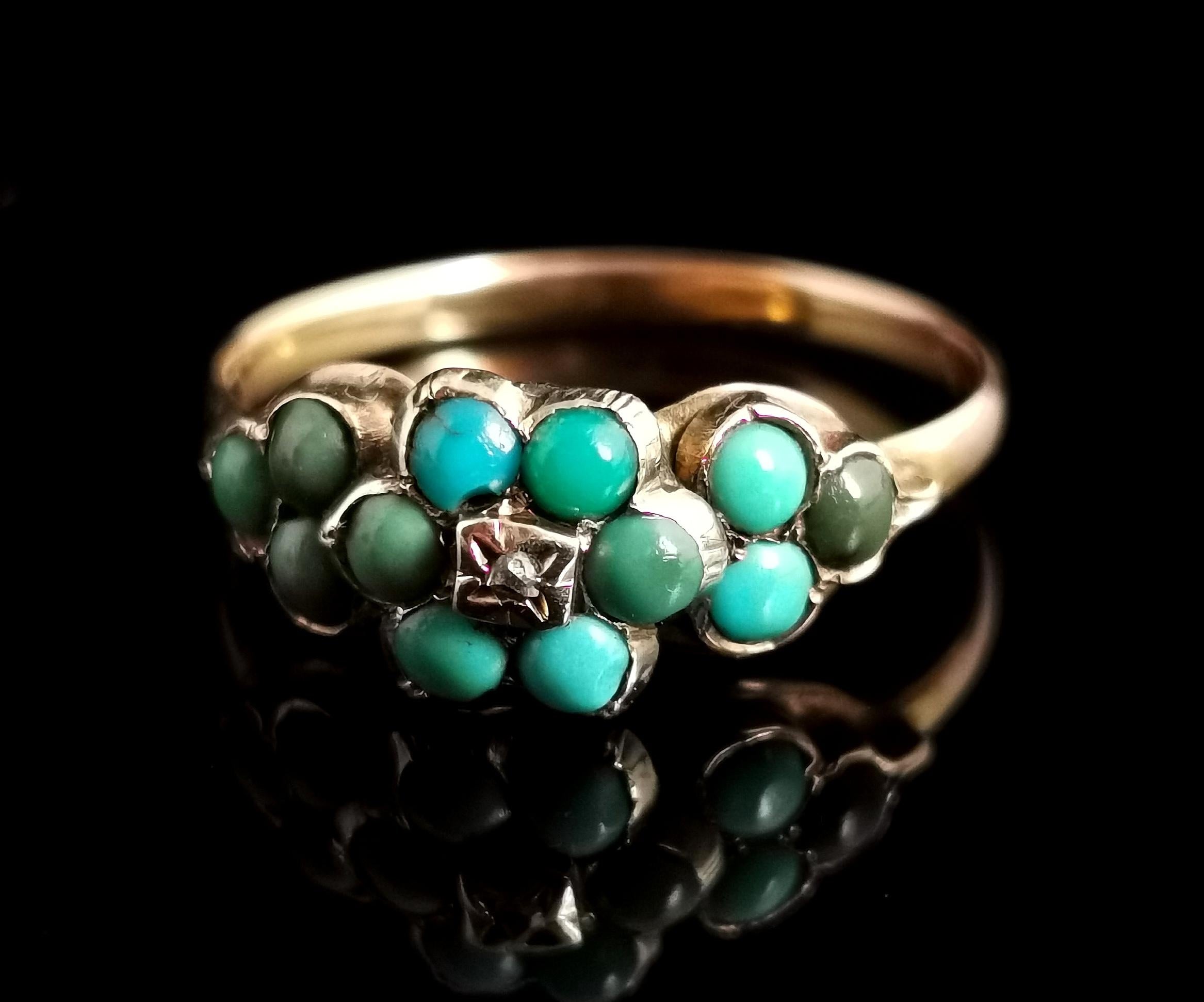 A pretty antique, Mid Victorian era turquoise and Rose cut diamond cluster ring.

The face of the ring features beautiful turquoise cabochons in an array of greens arranged as a forget me not flower with a further turquoise set trefoil to each