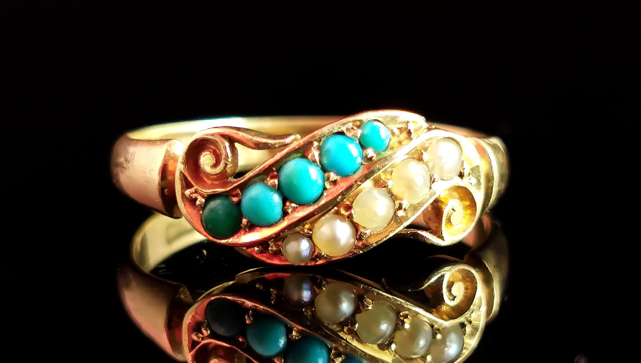 A truly beautiful antique, late Victorian Turquoise and pearl ring in 18kt yellow gold.

This ring has an unusual design and is truly a perfect combination of turquoise and creamy seed pearl.

It is set in rich 18kt yellow gold with with a scrolling