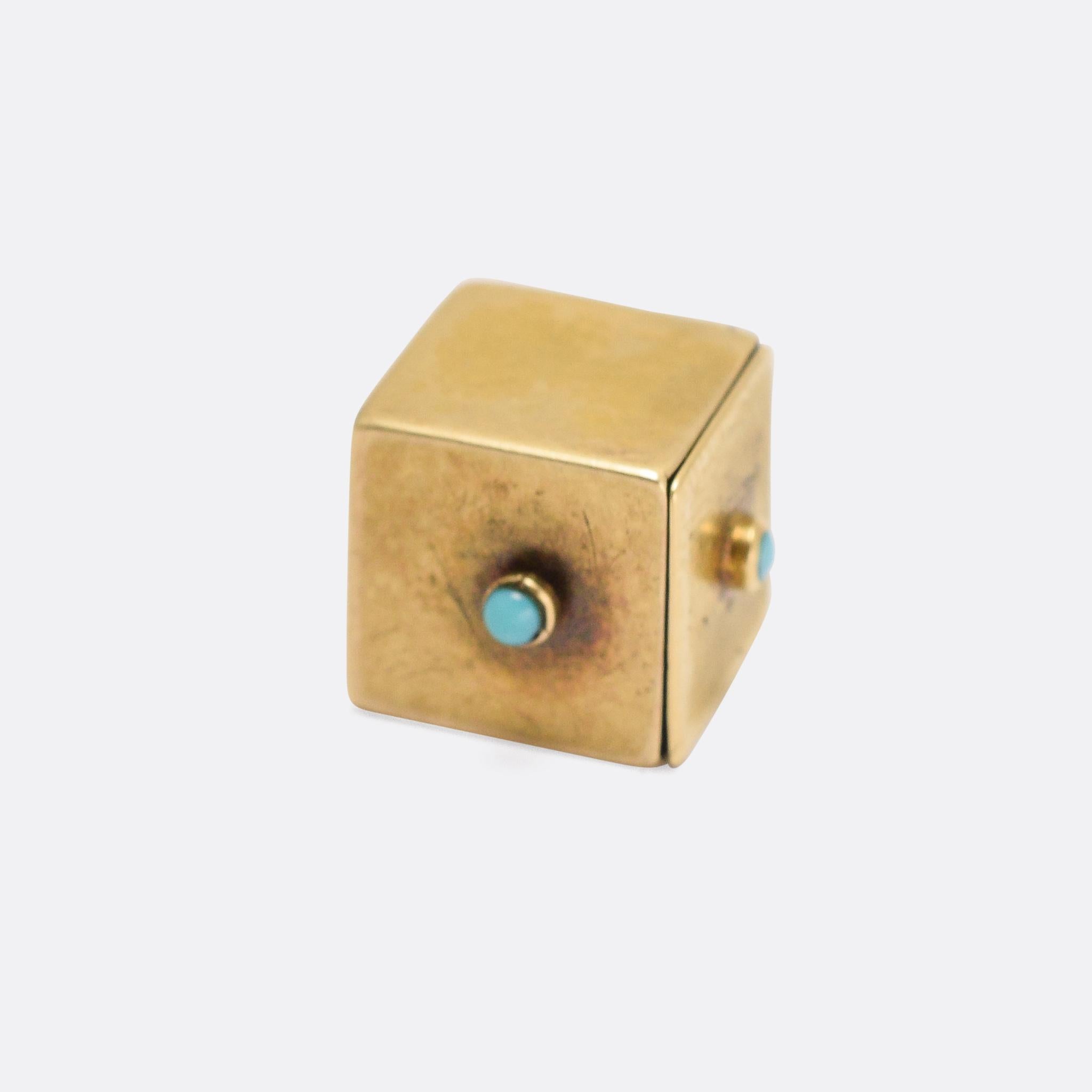 A cool antique charm... with a very sensible moral message. It's a cube (signifying a die), set with turquoise cabochons, and when pressed a certain way a ruby-eyed devil pops up. A simple reminder of the evils of gambling. Modelled in 15k yellow