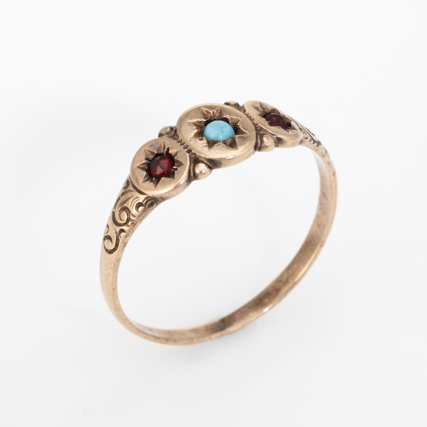 Victorian era signet ring (circa 1880s to 1900s), crafted in 10 karat rose gold.

1 x 2mm turquoise is accented with 2 x 1mm garnets.  

The ring is in excellent condition.

Particulars:

Weight: 1.4 grams

Stones: 1 x 2mm turquoise is accented with