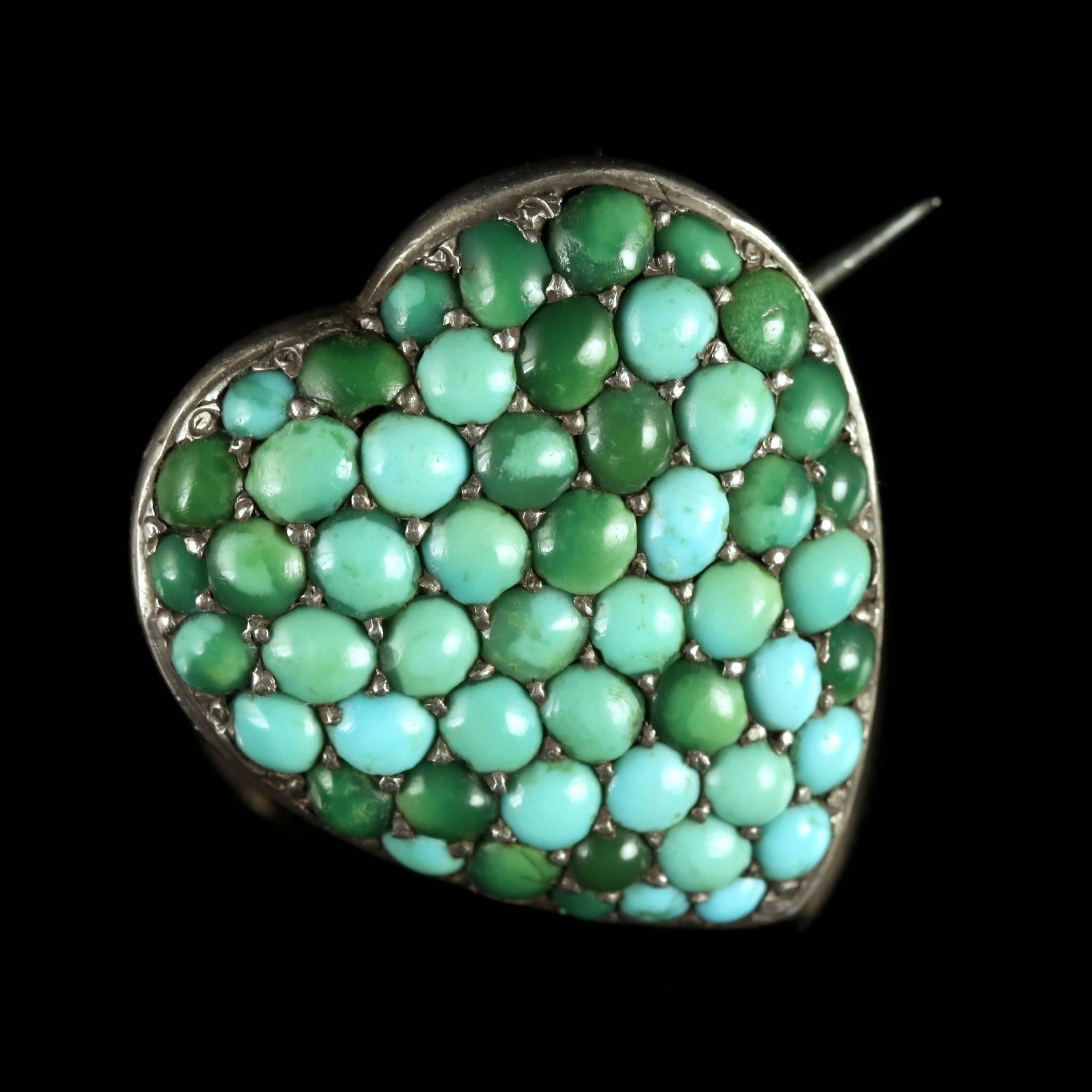 This charming Victorian heart Silver brooch is adorned with Turquoises, Circa 1900.

The brooch displays a number of Turquoise’s which compliment this little brooch beautifully.

On the reverse, a locket window can be seen so you can place a photo
