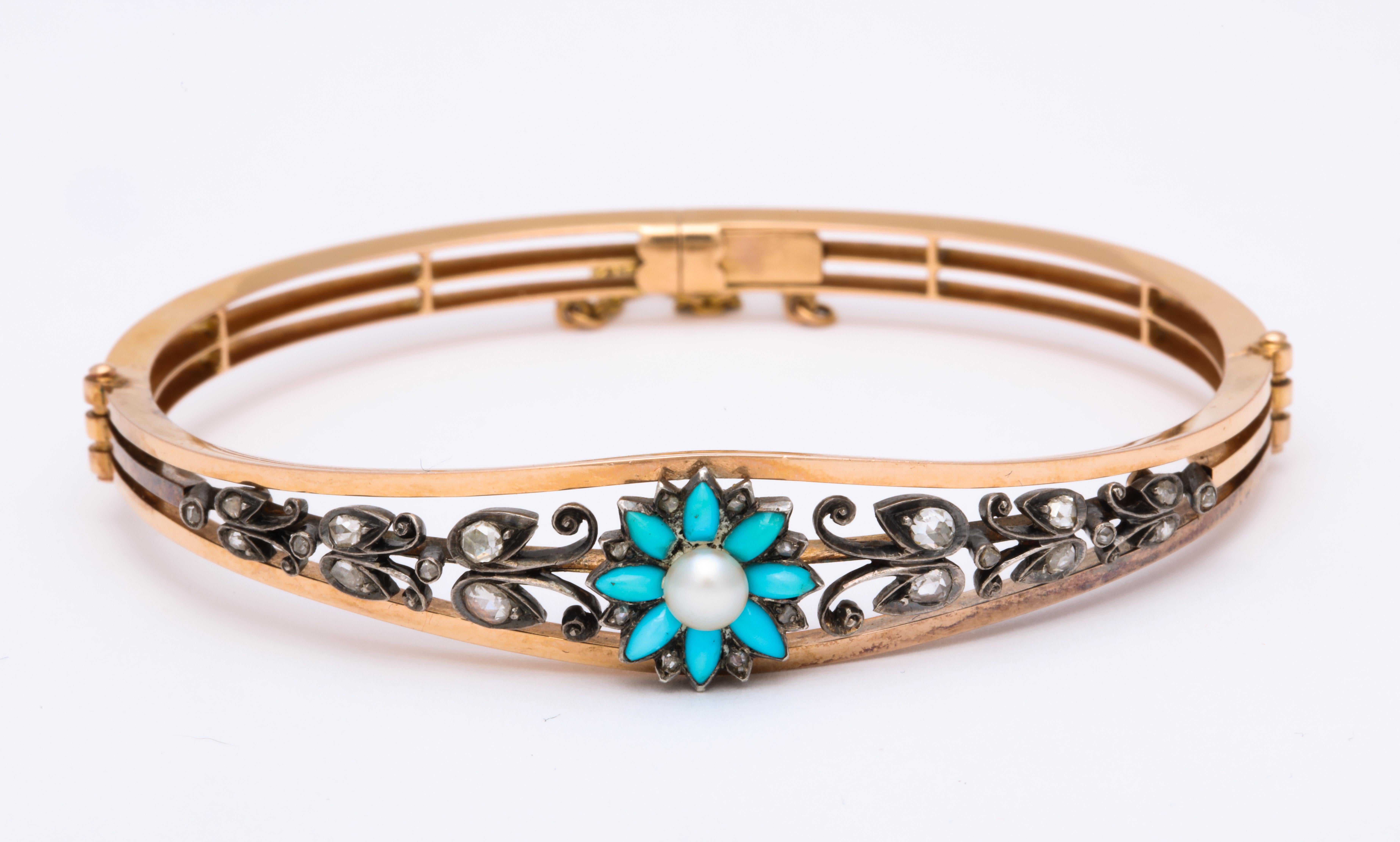 A fine, feminine, 18 kt bangle bracelet sets a Persian turquoise daisy with a natural pearl directly center bringing you warm thoughts of summer all year. Rose diamond dew drops, approximately .25 cts, rest on the leaves that wrap the top of your