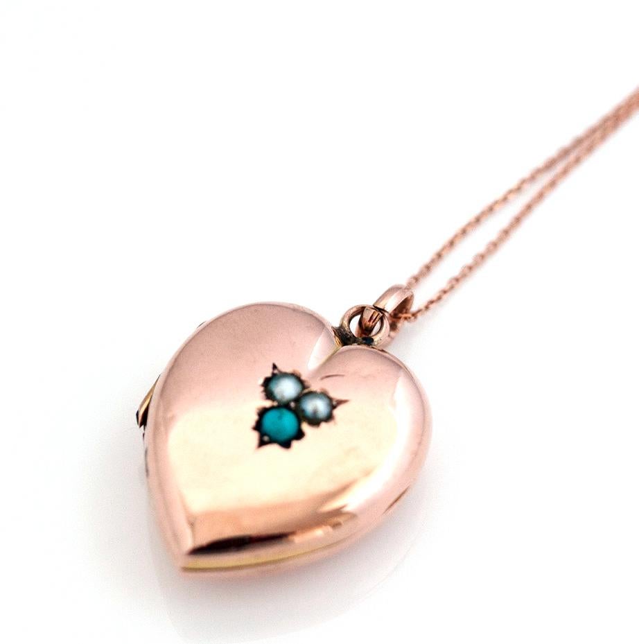 Antique Victorian locket featuring seed pearls and a single turquoise gemstone set in 9ct rose gold. The heart shaped locket hangs from a new 9ct gold chain. The locket is a gold 'back and front' locket which means the front and back of the locket