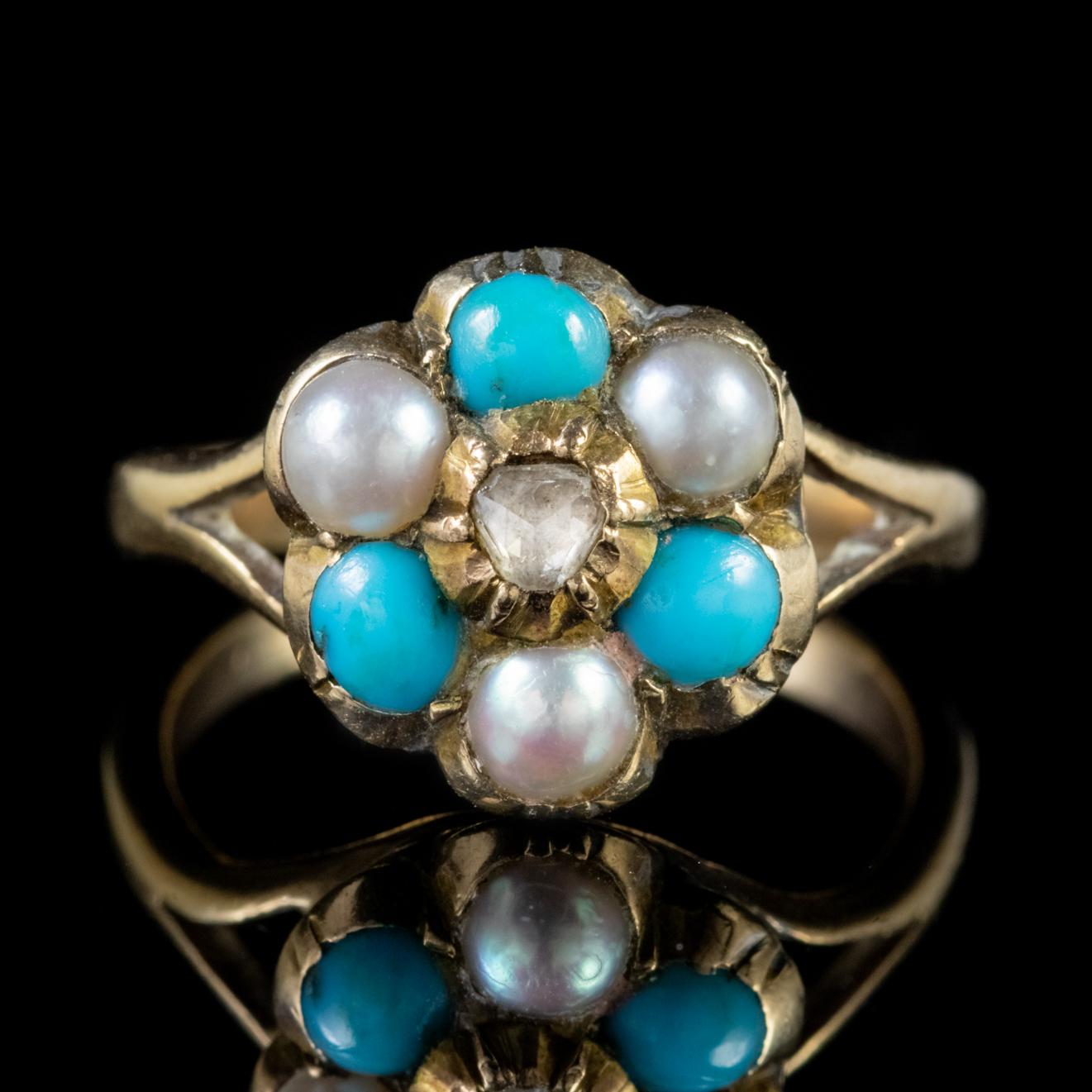 An exquisite Antique cluster ring adorned with Pearls and Turquoise stones arranged in a lovely flower shaped cluster with a Rose cut Diamond twinkling in the centre. 

Turquoise are a lovely opaque stone with a calming blue/ green colour and have