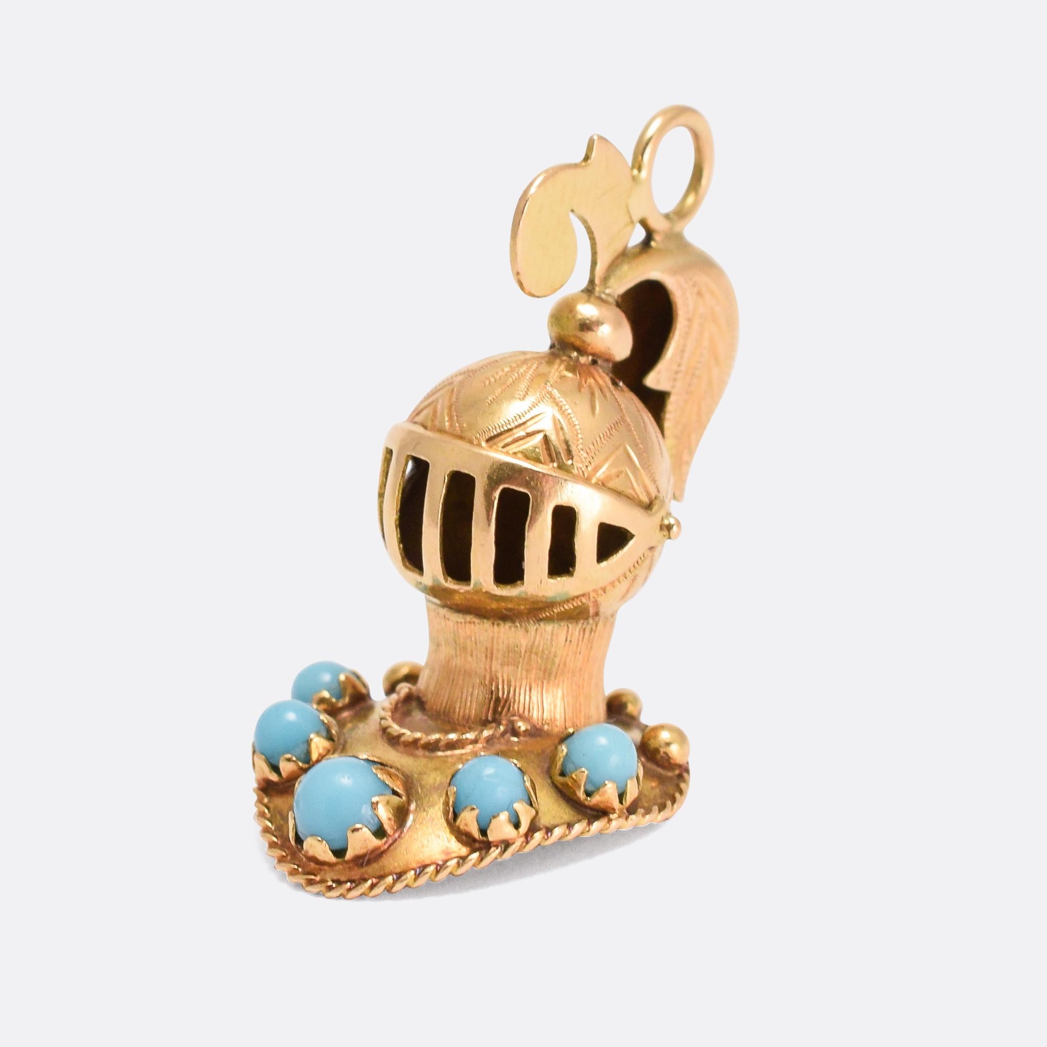 A cool antique Knight's Helm pendant dating from the Victorian era. Constructed from 9k yellow gold throughout, it's set with five turquoise cabochons and wonderfully crafted with openworked visor, applied ropework, feather plume, and hand-chased