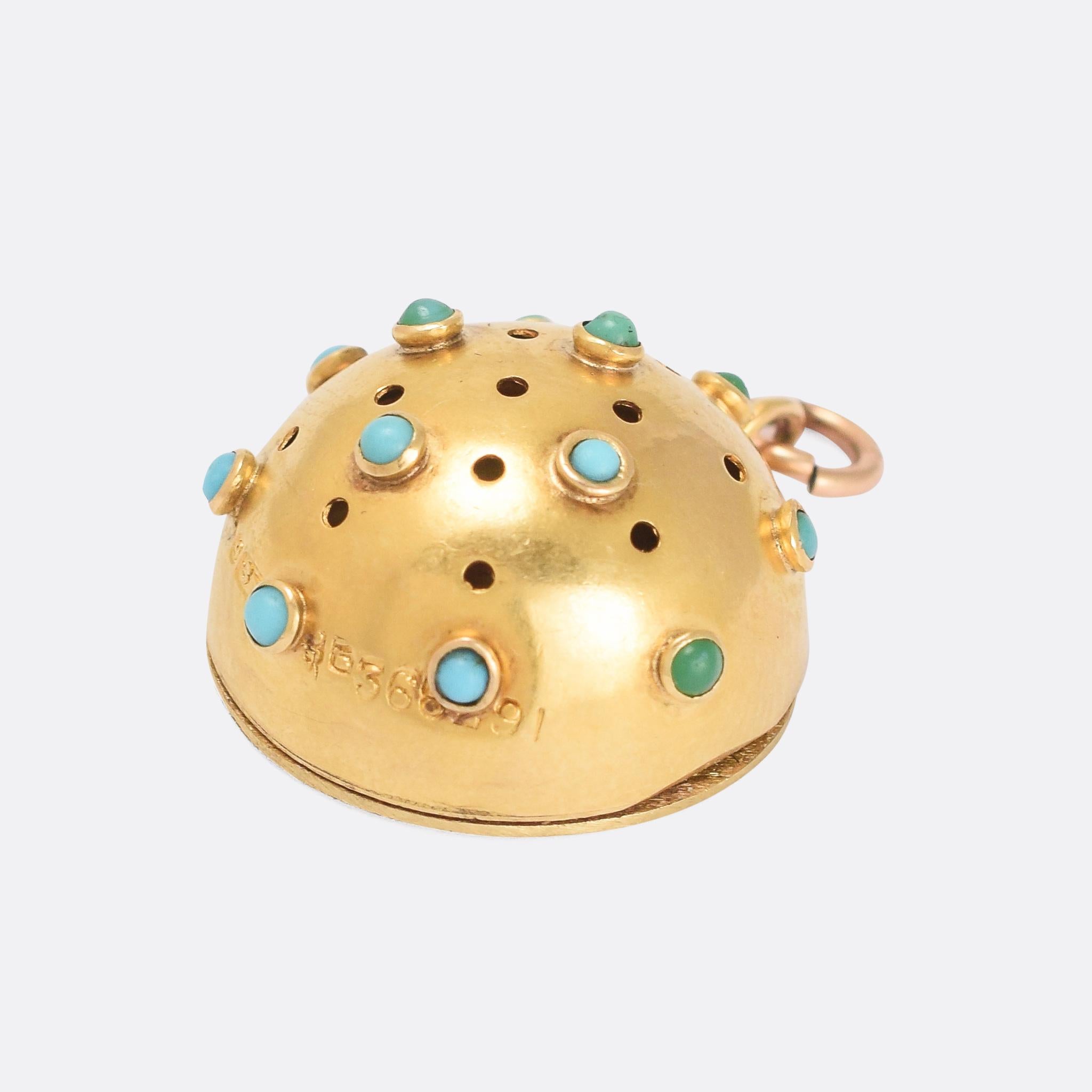 A cool Victorian vinaigrette pendant modelled as a hemisphere and studded with turquoise cabochons. The back opens to store a scent-soaked piece of fabric or foam and the front features tiny little holes, allowing the wearer to disguise unpleasant