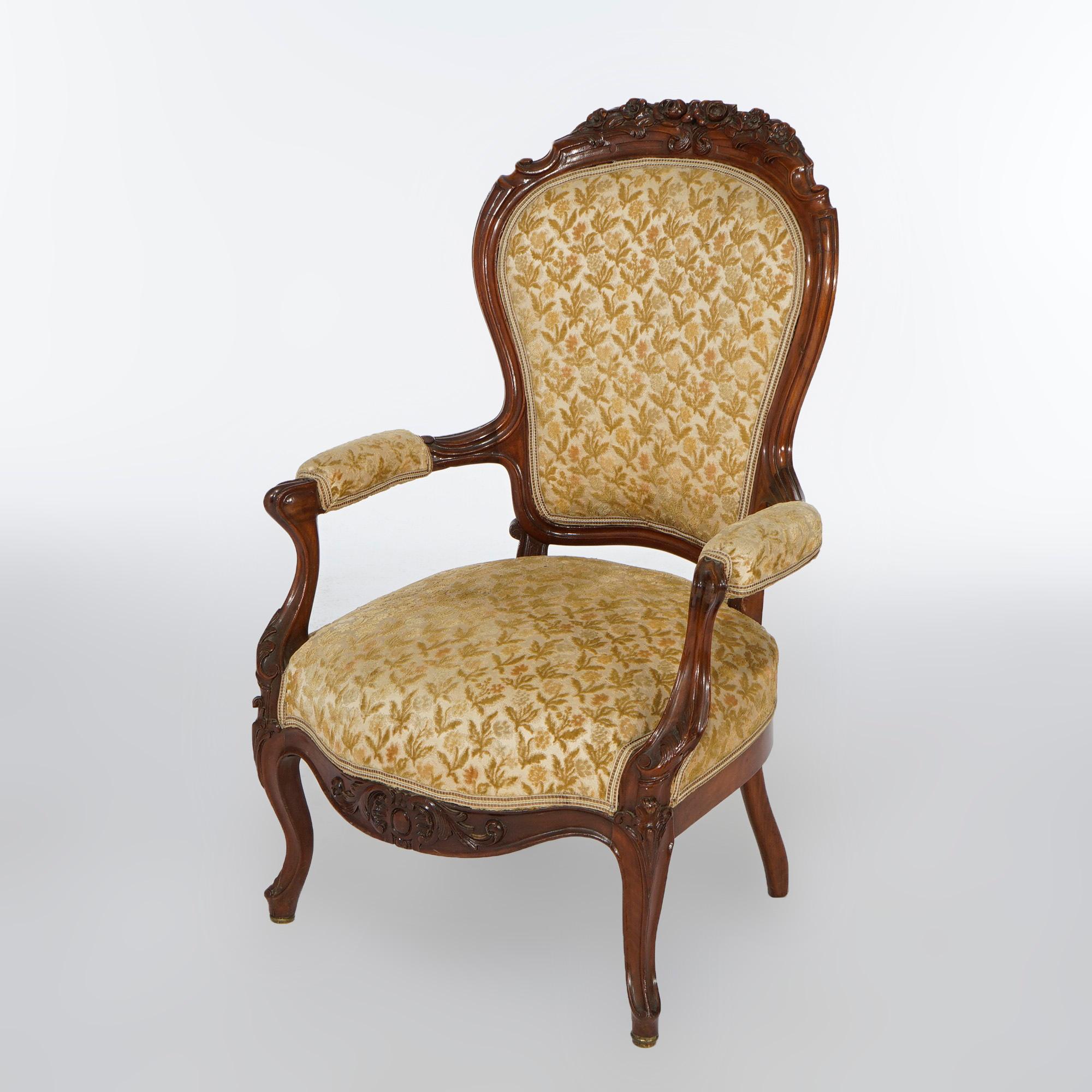 An antique Victorian parlor chair offers walnut frame with carved floral crest over upholstered back and seat, raised on cabriole legs, c1890

Measures- 41.25''H x 26.5''W x 27''D.